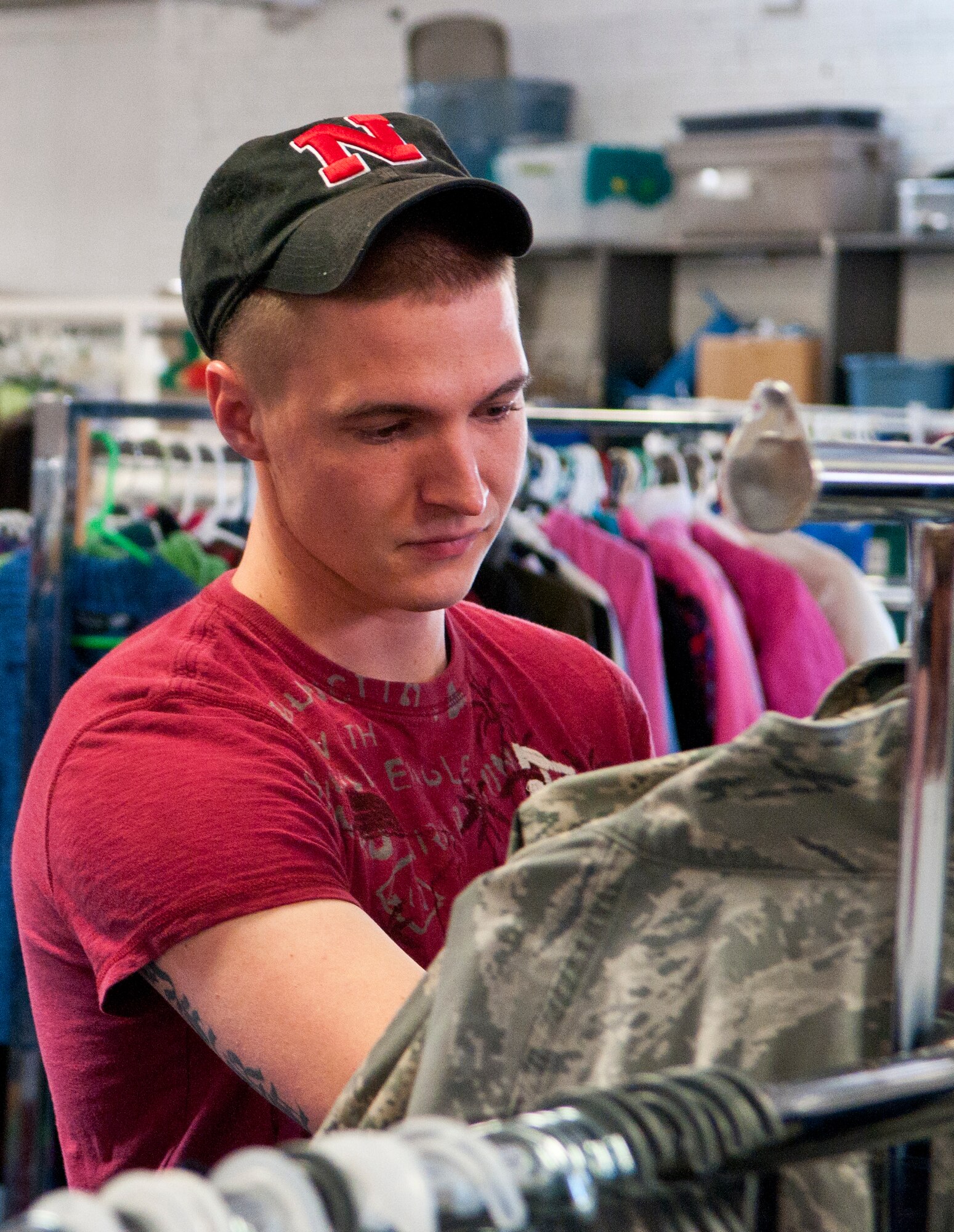 Senior Airman Zachary Byerly, 90th Missile Security Forces Squadron, sorts through a rack of ABUs in the Airman’s Attic June 2. The Airman’s Attic has a selection of free uniform items, and other useful wares. (U.S. Air Force photo by Airman Jason Wiese)