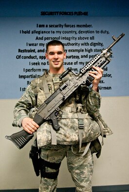 Airman 1st Class Bryce Bates, 90th Security Forces Squadron, poses in Building 34 with an M-240 machine gun and other gear that he will take with him to safeguard the nation’s critical assets May 18 on F. E. Warren Air Force Base, Wyo. (U.S. Air Force photo by Airman Jason Wiese)
