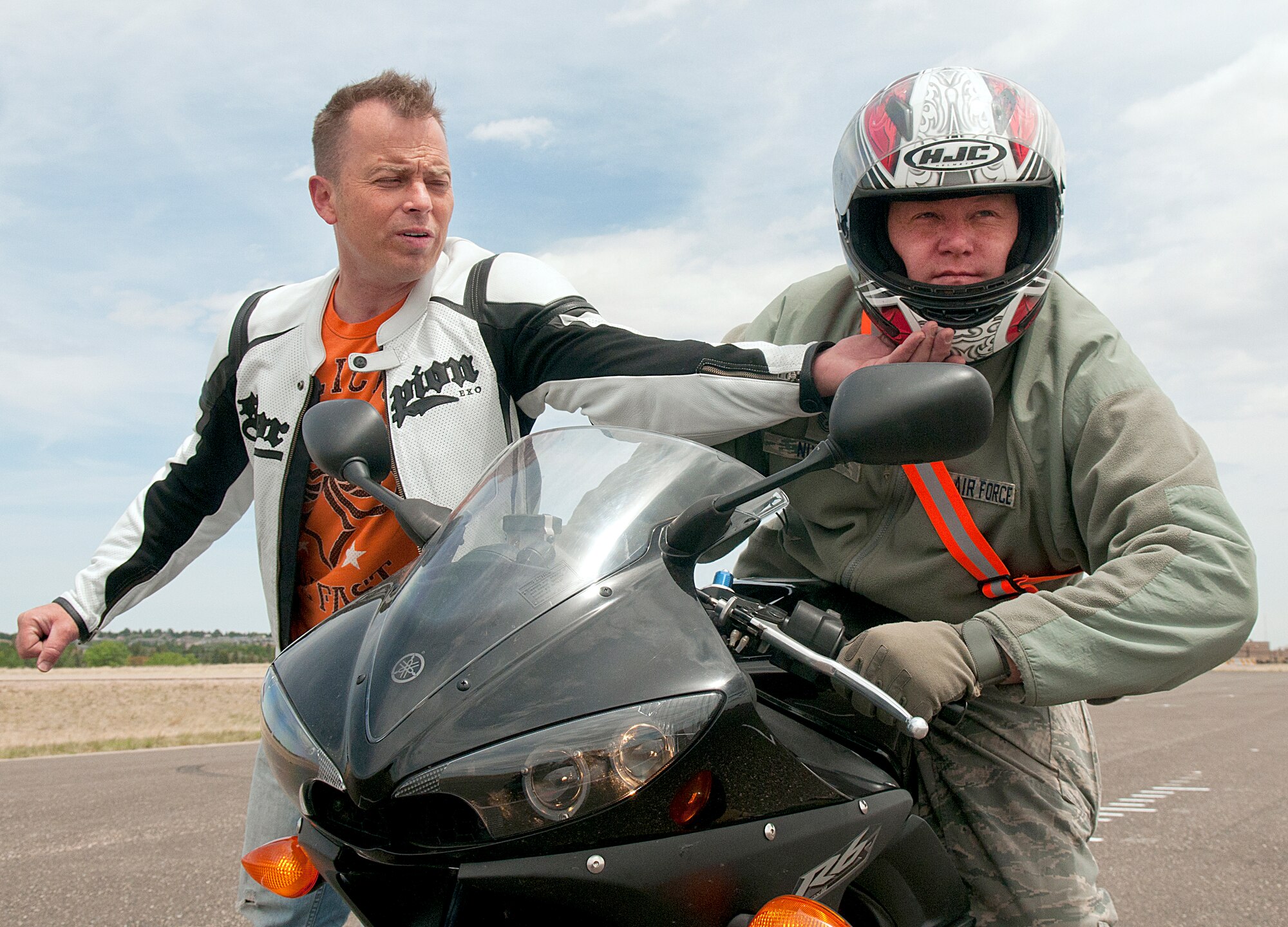Tech. Sgt. Christopher Laubin, 90th Operations Group, helps Tech. Sgt. Richard Nixon, 90th Missile Maintenance Group, with his form during the field portion of the first Military Sportbike Rider Course offered by the 90th Missile Wing traffic safety office May 30 at F. E. Warren Air Force Base, Wyo. (U.S. Air Force photo by R.J. Oriez)
