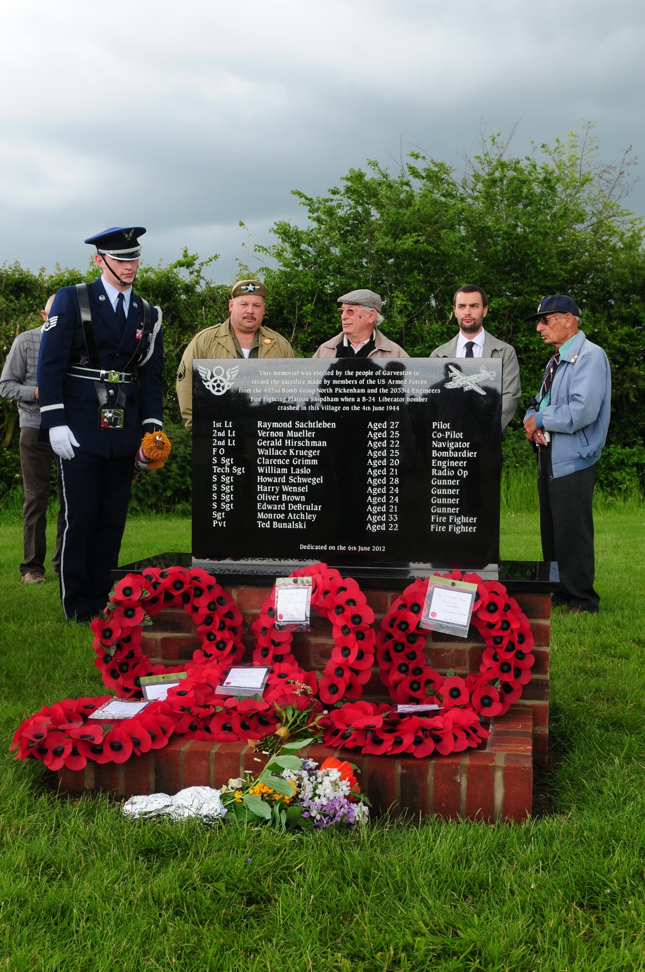 GARVESTON, England – Ceremony attendees pay their respects to the newly unveiled Garveston Memorial June 6, 2012.  On June 4, 1944 an Army Air Corps B-24 Liberator Bomber crashed near the village, killing 10 crew members and two firemen. The memorial was dedicated by a committee formed by those who witnessed the crash over 60 years ago. (U.S. Air Force photo by Airman 1st Class Cory D. Payne)