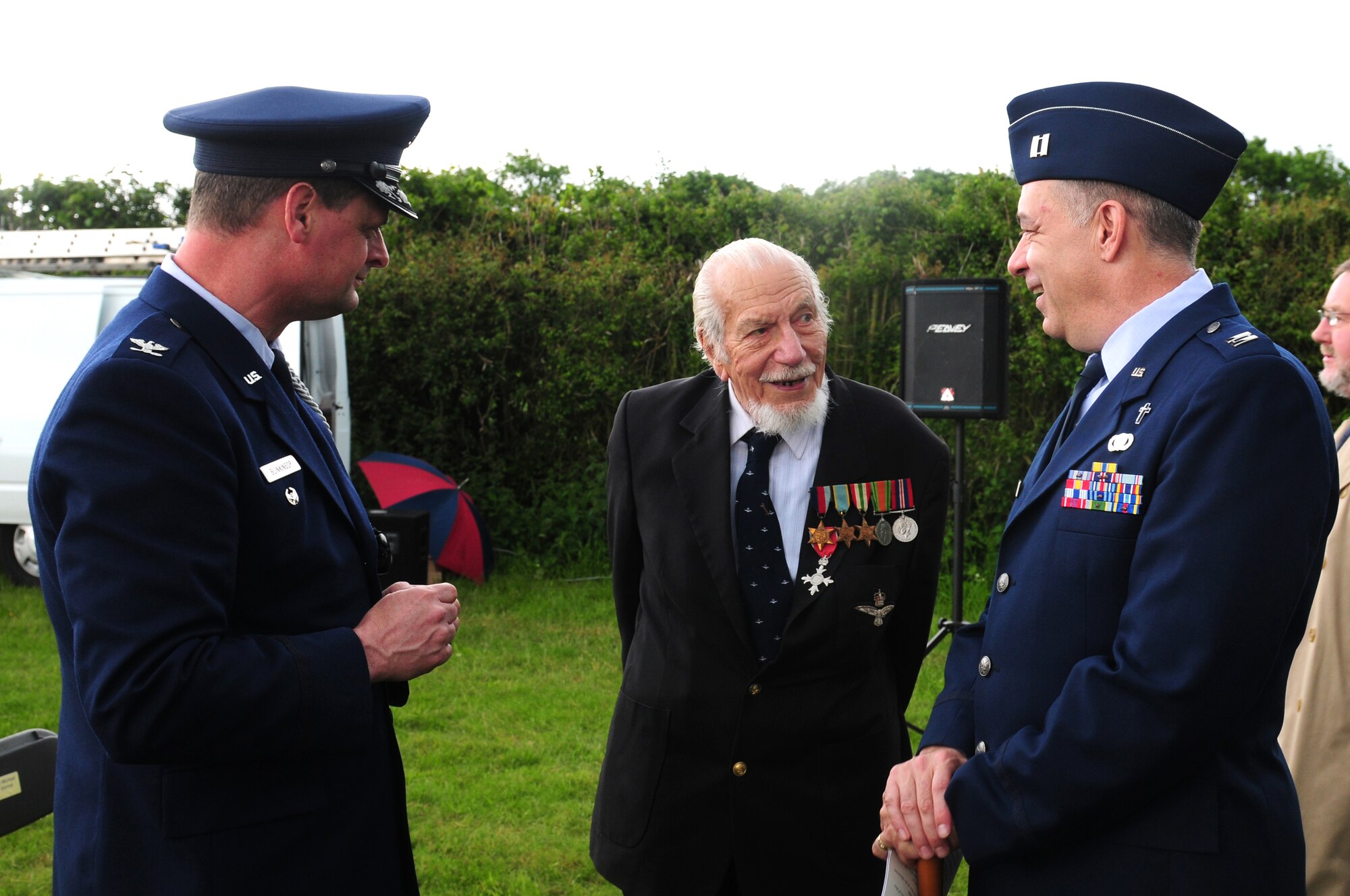 GARVESTON, England - Col. Sonny Blinkinsop (left), U.S. Air Attaché to the United Kingdom, and Capt. Joseph Fisher (right), 48th Fighter Wing chaplain, speaks with Kenneth Wallis, retired Royal Air Force wing commander, after the unveiling of the Garveston Memorial June 6, 2012.  On June 4, 1944 an Army Air Corps B-24 Liberator Bomber crashed near the village, killing 10 crew members and two firemen. The memorial was dedicated by a committee formed by those who witnessed the crash over 60 years ago. (U.S. Air Force photo by Airman 1st Class Cory D. Payne)