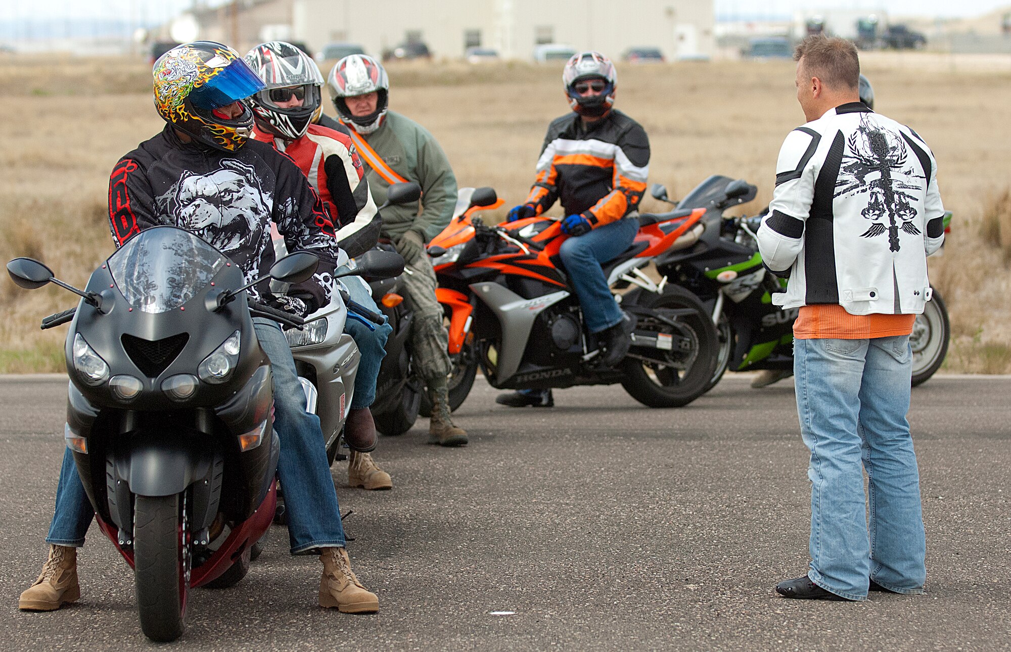 Students in the first Military Sportbike Rider Course offered by the 90th Missile Wing traffic safety office at F. E. Warren Air Force Base, Wyo., listen to instructor Tech. Sgt. Christopher Laubin, 90th Operations Group, explain an exercise during the field portion of the course May 30. (U.S. Air Force photo by R.J. Oriez)
