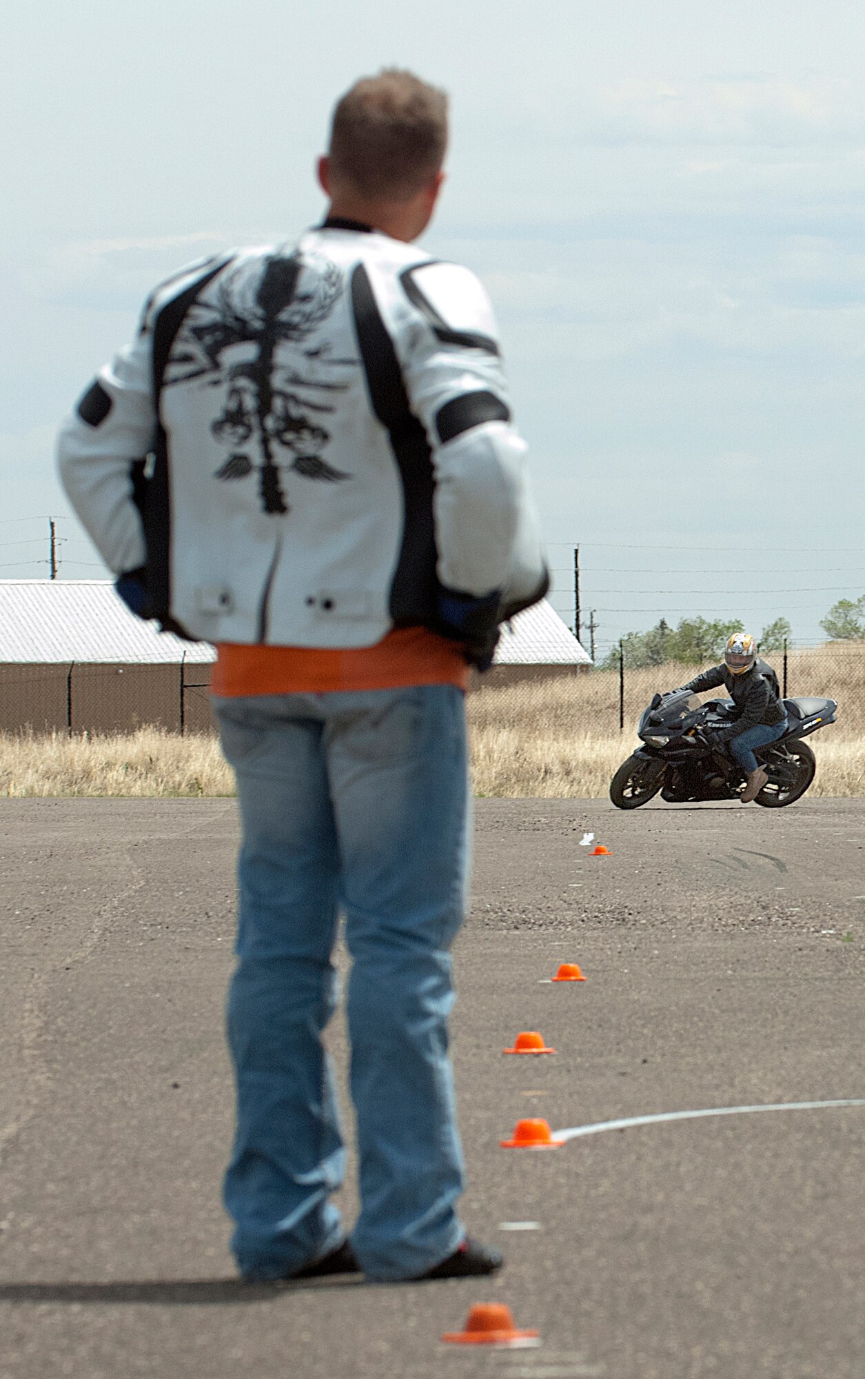 Staff Sgt. James Derbyshire, 90th Maintenance Operations Squadron, turns a corner under the watchful eye of Military Sportbike Rider Course instructor Tech. Sgt. Christopher Laubin, 90th Operations Group, May 30. Derbyshire was taking part in the first MSRC offered by the 90th Missile Wing traffic safety office at F. E. Warren Air Force Base, Wyo. Air Force Global Strike Command requires active-duty sportbike riders to attend a MSRC in addition to the basic riders course all motorcycle riders go through. (U.S. Air Force photo by R.J. Oriez)