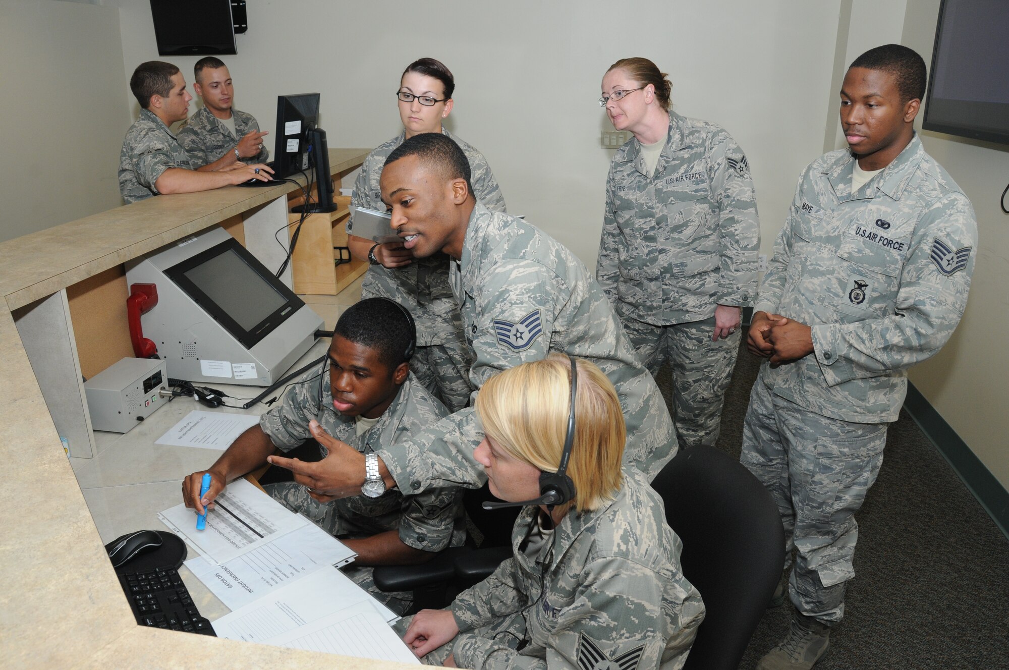 Staff Sgt. Trae Clark, 334th Training Squadron aviation resource management instructor, trains students on the operations desk in the squadron/host aviation resource management lab at Cody Hall June 1, 2012, at Keesler Air Force Base, Miss.  Clark is the 2011 Air Force aviation resource management instructor of the year.  (U.S. Air Force photo by Kemberly Groue)