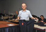 Airman Mitchell Imlah holds size 41 trousers, the largest available at basic training May 18 at the clothing issue facility. Now wearing a size 32, at one time, Imlah wore size 46 trousers before losing weight and joining the Air Force. (U.S. Air Force photo/Alan Boedeker)