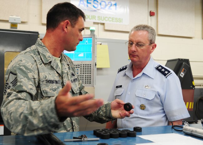 Lt. Gen. Mark Ramsay, 18th Air Force commander, listens to Master Sgt. Timothy Thornton a machinist at the JB Charleston 437th Airlift Wing Aircraft Metals technology shop June 4, 2012. Ramsay visited JB Charleston to get a first-hand look at the military functions that are unique to this base. (U.S. Air Force photo/Staff Sgt. Katie Gieratz) 
