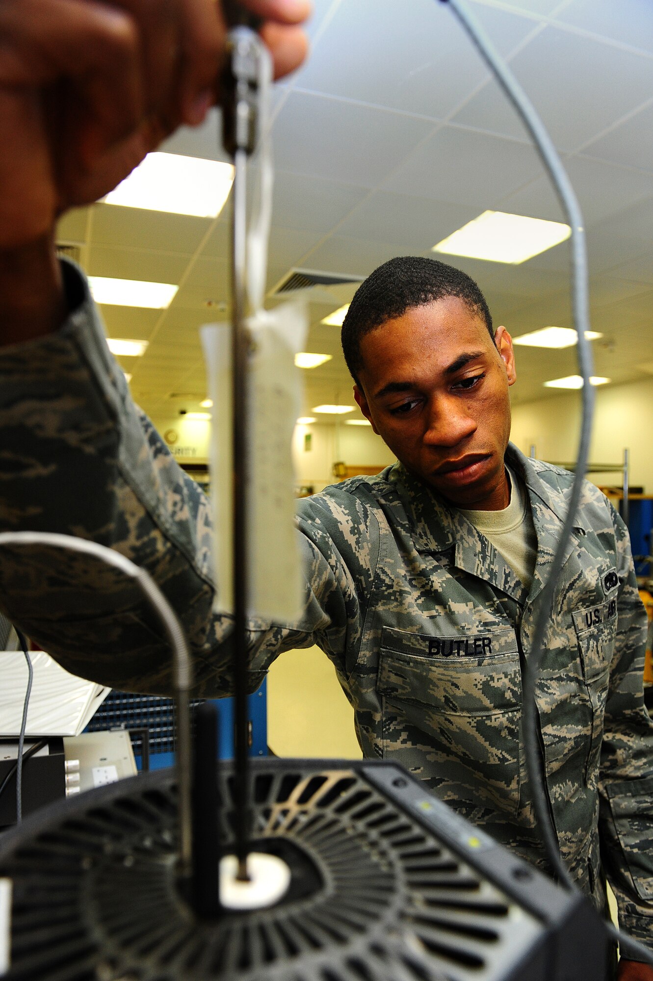 Senior Airman Dante Butler, 86th Maintenance Squadron precision measurement equipment laboratory journeyman, forms a triple point of water on Ramstein Air Base, Germany, June 5, 2012. The triple point of a substance is the temperature and pressure at which three phases, (gas, liquid, and solid), of that substance may coexist in thermodynamic equilibrium. The laboratory currently supports 13,842 items in their area of responsibility and on average, calibrates, troubleshoots, and repairs more than 1,000 items monthly. (U.S. Air Force photo/Brea Miller)