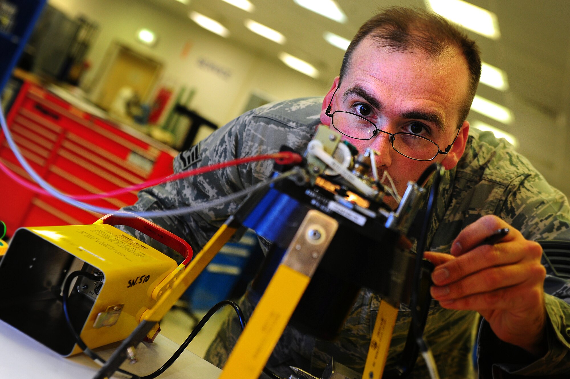 Staff Sgt. Ryan Berry, 86th Maintenance Squadron Test Measurement and Diagnostic Equipment technician, calibrates a guided weapon test set on Ramstein Air Base, Germany, June 5, 2012. The laboratory currently supports 13,842 items in their area of responsibility and on average, calibrates, troubleshoots, and repairs more than 1,000 items monthly. (U.S. Air Force photo/Brea Miller)