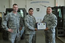 MINOT AIR FORCE BASE, N.D. -- Master Sgt. Roy Hensley, Vice President of Minot Top-3, and Master Sgt. Danny Christ, President of Minot Top-3, presented Senior Airman Daniel Umana, of the 5th Munitions Squadron, with the Minot Top-3 Association's Excellence award for the month of May. Top-3 members recognize a member of Team Minot for going above and beyond in support of the 5th Bomb Wing and or the 91st Missile Wing missions each month by presenting them with a Top-3 recognition in excellence award. (U.S. Air Force photo/Senior Airman Jesse Lopez)