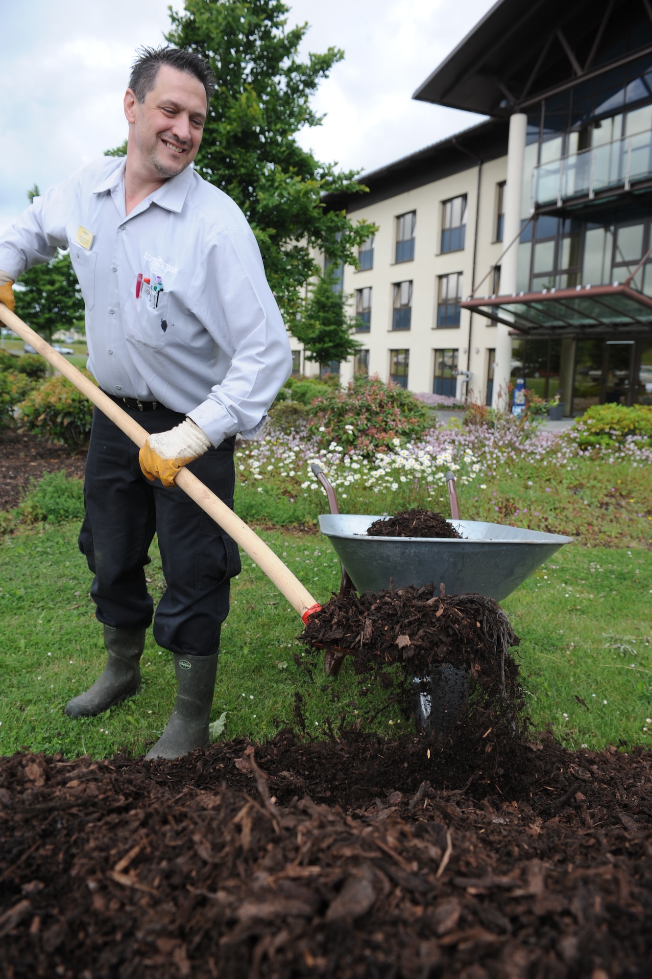 SPANGDAHLEM AIR BASE, Germany – Martin Molli, Eifel Arms Inn maintenance worker, shovels mulch to be put into the Eifel Arms Inn entryway flower gardens here. The Eifel Arms Inn maintenance section works in conjunction with the 52nd Civil Engineer squadron to ensure plumbing, electrical, mechanical and landscape fixtures and amenities are functional. is gearing up to be evaluated for the Innkeeper Competition June 17-20. All Sabers are welcome to show support to the lodging team at the opening of the competition 8 a.m. June 18 at Club Eifel. Support and representation from the Saber community is vital to the lodging team’s success in this competition. (U.S. Air Force photo by Senior Airman Natasha Stannard/Released)
