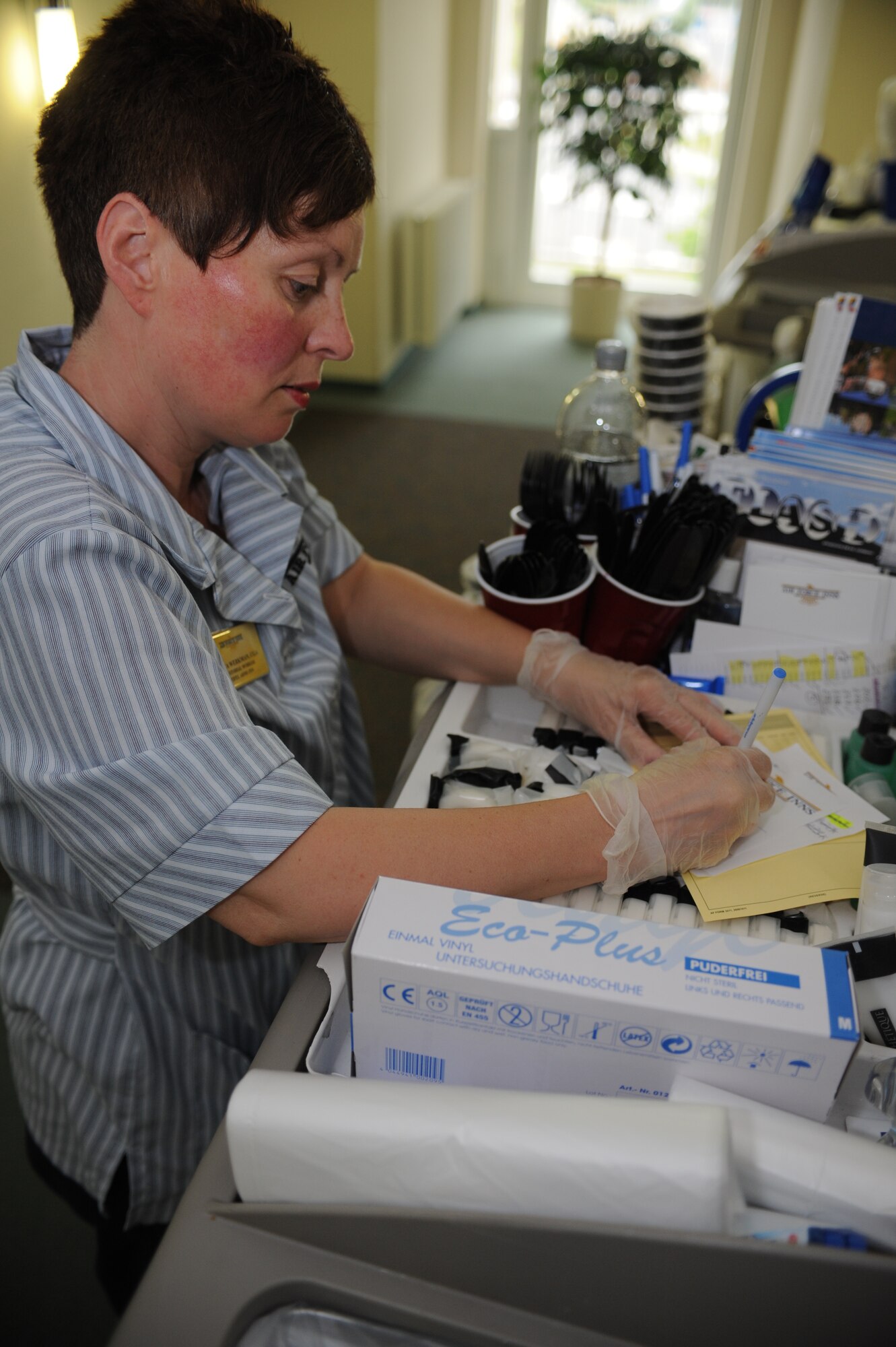 SPANGDAHLEM AIR BASE, Germany – Sonja Werkman, Eifel Arms Inn custodial worker, writes her name and the names of her colleagues on welcome notes for guests June 7 at the Eifel Arms Inn here. Custodial workers leave these notes to introduce themselves as the housekeeper for the room and let the guests know they serviced the room. The Eifel Arms Inn served approximately 27,000 guests last year and is gearing up to be evaluated for the Innkeeper Competition June 17-20. All Sabers are welcome to show support to the lodging team at the opening of the competition 8 a.m. June 18 at Club Eifel. Support and representation from the Saber community is vital to the lodging team’s success in this competition. (U.S. Air Force photo by Senior Airman Natasha Stannard/Released)