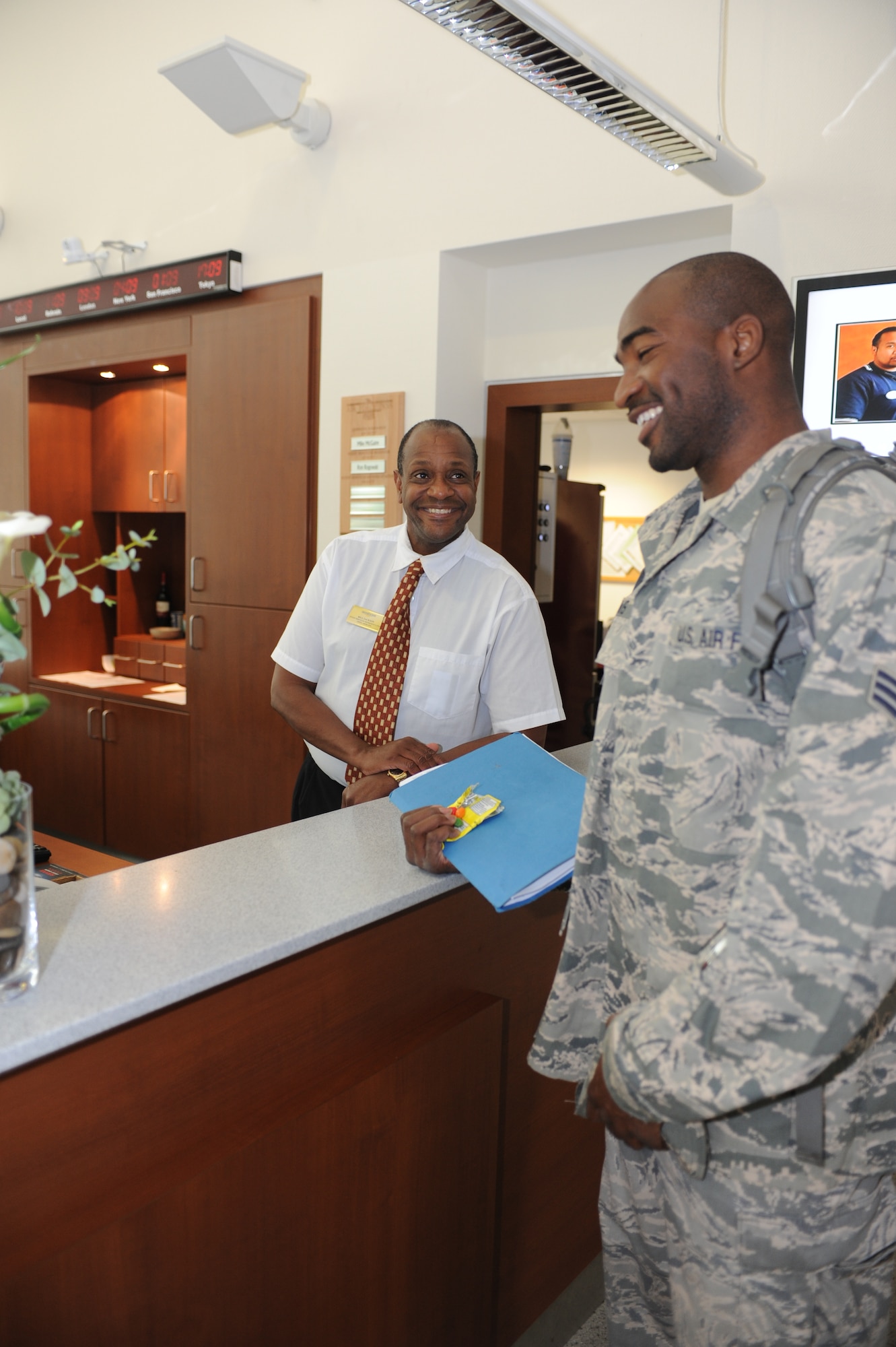 SPANGDAHLEM AIR BASE, Germany – Bill Jackson, Eifel Arms Inn guest services representative, answers Senior Airman James Lewis’, 52nd Comptroller Squadron budget analyst, questions regarding his length of stay June 7 at Eifel Arms Inn here. Lewis moved to Spangdahlem from Buckley Air Force Base, Colo. and is staying at the inn while he searches for a home here.  The Eifel Arms Inn served approximately 27,000 guests last year and is gearing up to be evaluated for the Innkeeper Competition June 17-20. All Sabers are welcome to show support to the lodging team at the opening of the competition 8 a.m. June 18 at Club Eifel. Support and representation from the Saber community is vital to the lodging team’s success in this competition. (U.S. Air Force photo by Senior Airman Natasha Stannard/Released)

