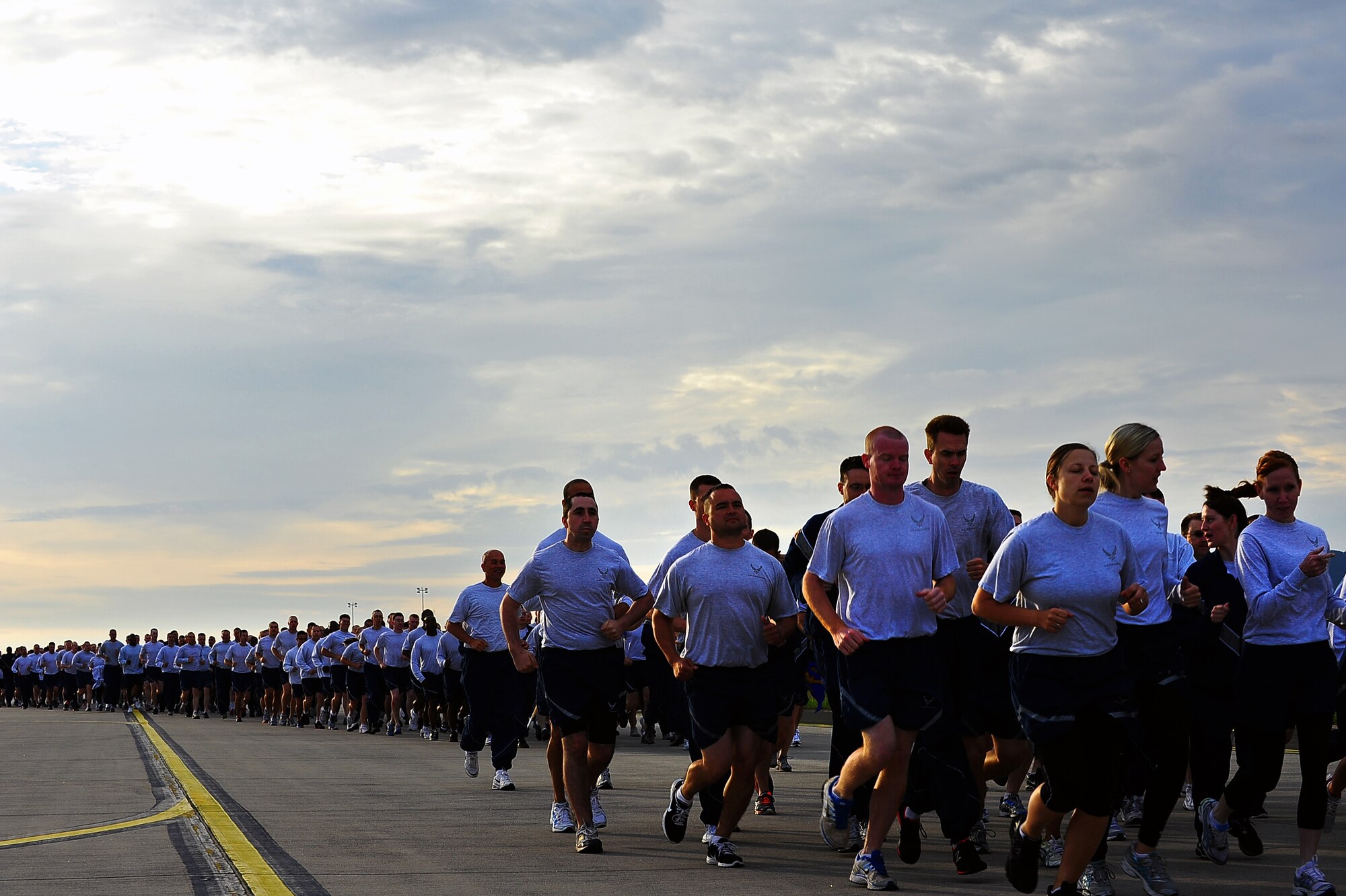 Air Force members run during the Wing Warrior Run on the flightline at Ramstein Air Base, Germany, June 7, 2012. The wing run is scheduled to occur the first Thursday of every month to promote esprit de corps and unity as well as emphasize the importance of fitness. (U.S. Air Force Airman Basic Brea Miller)