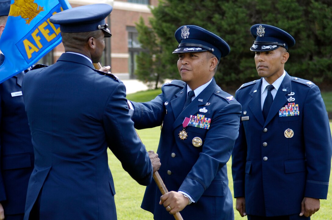 Col. Roy-Alan Agustin (center) relinquishes command of the Joint Base Anacostia-Bolling Air Force Element to Air Force District of Washington Commander Maj. Gen. Darren McDew during a Change of Command Ceremony on the U.S. Air Force Ceremonial Lawn June 6 at JBAB, Washington, D.C. Col. Michael Saunders (right)  assumed command and is also now the JBAB vice commander. (U.S. Navy photo by Seaman Justin Ray)