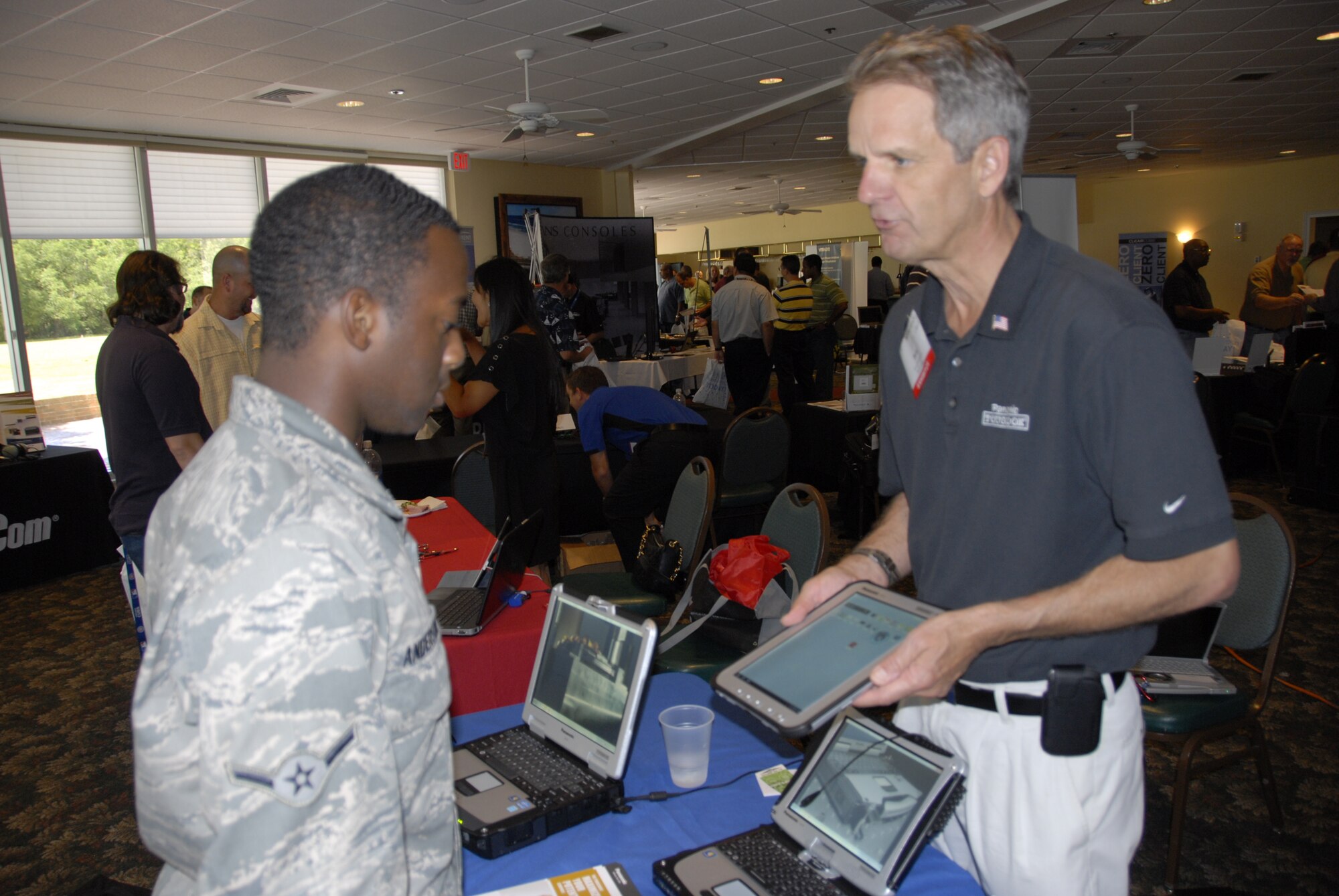 Airman Rodney Johnson, a member of the 919th Logistics Readiness Squadron at Duke Field, is introduced to the latest computer equipment by Bob Johnson, Panasonic area sales manager, at the technology expo at Eglin Air Force Base June 7. The annual event gives vendors from different companies an opportunity to showcase new products and ideas in hopes that mission effectiveness will be improved with the technological advances. (U.S. Air Force photo/Kevin Gaddie)