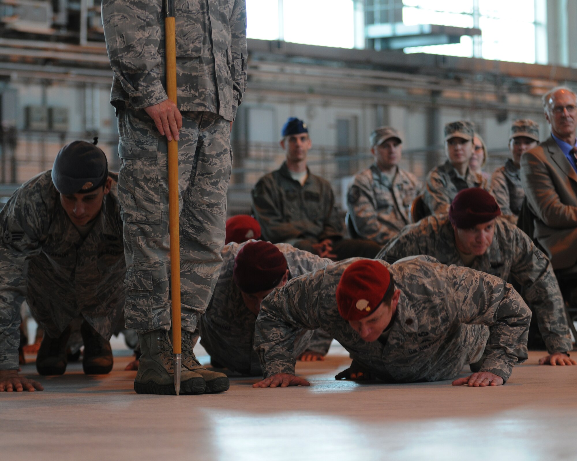 Special operations Airmen perform their final set of pushups with outgoing commander, Lt. Col. Jason Daniels, at the 321st Special Tactics Squadron change-of-command ceremony at RAF Mildenhall June 8, 2012.  Maj. Travis Woodworth assumed command from Daniels. (U.S. Air Force photo/Master Sgt. Kevin Wallace)