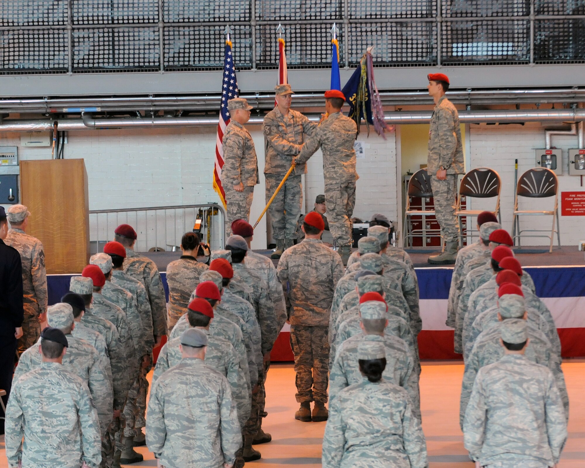 Col. Gary McCollum, 352nd Special Operations Group commander, passes the 321st Special Tactics Squadron guidon to the first sergeant, who then passed the guidon to Maj. Travis Woodworth, officially passing command of the 321st STS to Woodworth, during a change-of-command ceremony at RAF Mildenhall June 8, 2012. Lt. Col. Jason Daniels relinquished command of the unit. (U.S. Air Force photo/Master Sgt. Kevin Wallace)