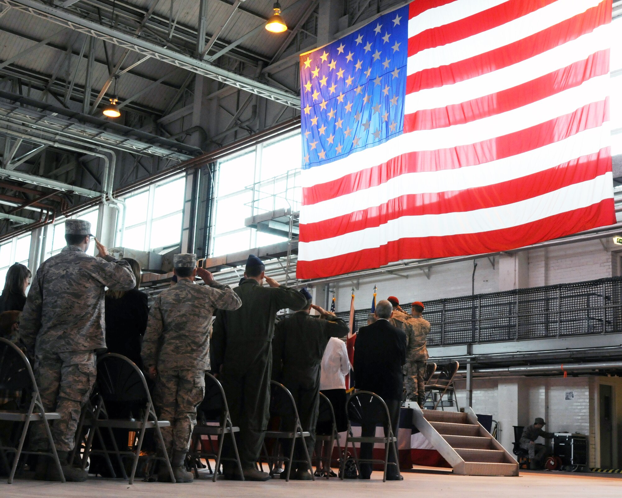 A formation of special operations Airmen salute during the National Anthem at the 321st Special Tactics Squadron change-of-command ceremony at RAF Mildenhall June 8, 2012.  Maj. Travis Woodworth assumed command from Lt. Col. Jason Daniels. (U.S. Air Force photo/Master Sgt. Kevin Wallace)