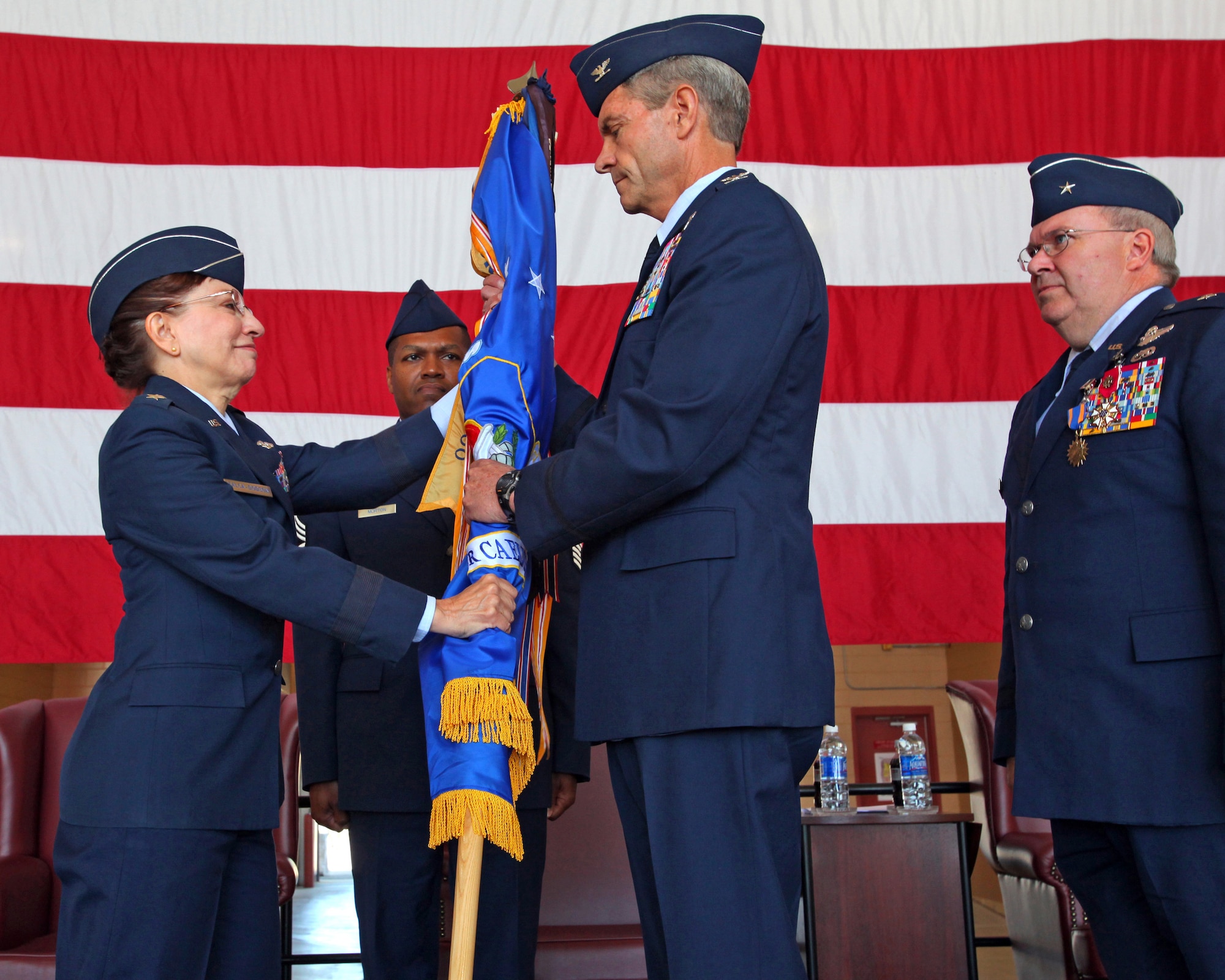 Col. Kevin J. Keehn accepts the 108th Wing’s flag from Maj. Gen. Maria Falca-Dodson, New
Jersey Air National Guard commander, during a Change of Command ceremony here in front of his wife, Connie, and children May 20. (U.S. Air Force courtesy photo/Released)