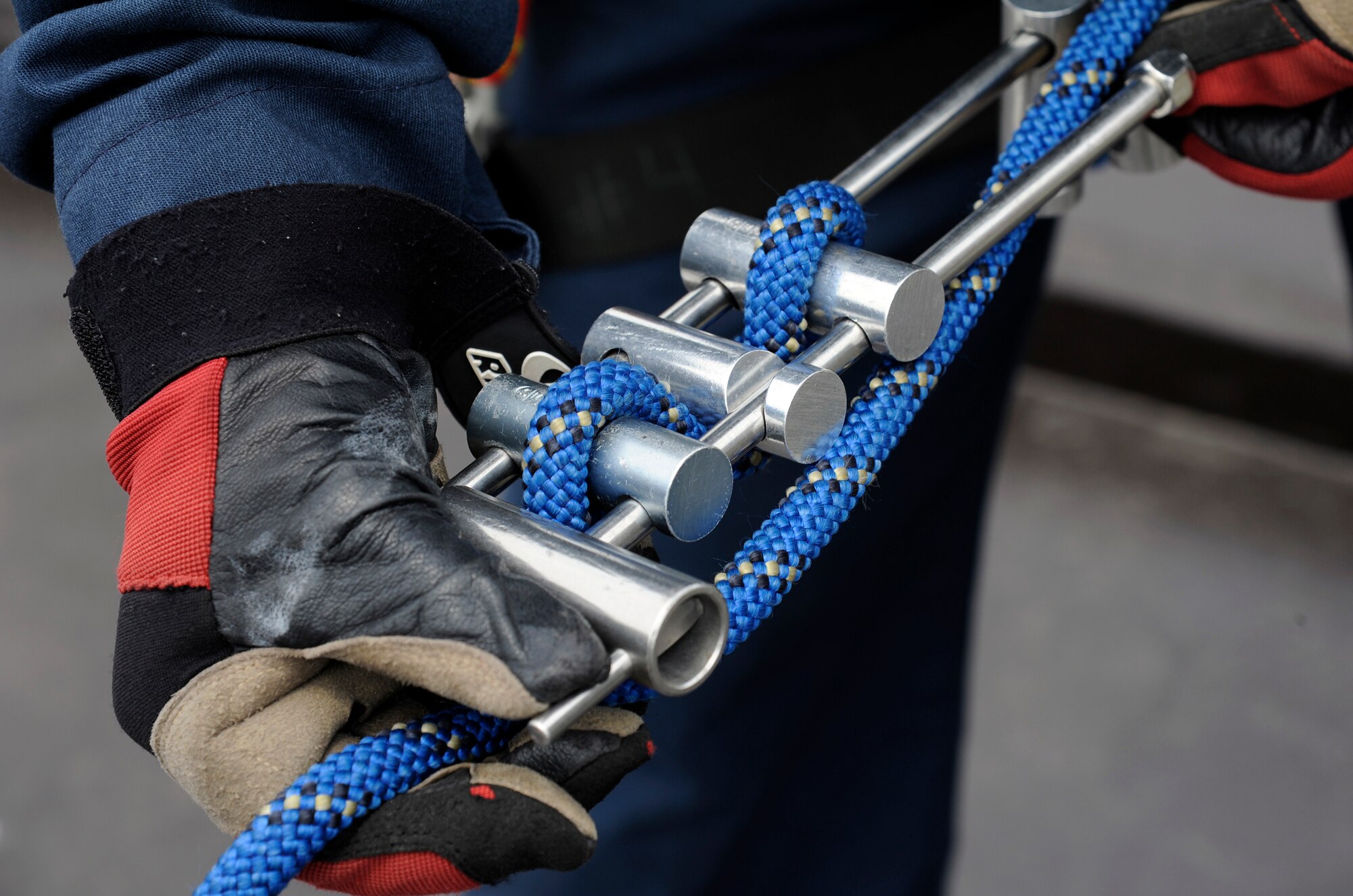 Takuya Kanto, 35th Civil Engineer Squadron driver operator, secures a rope onto a brake bar during rappel training at the Misawa water tower at Misawa Air Base, Japan, June 8, 2012. The brake bar is used to control the friction and tension of the rope as the individual rappels to the ground. (U.S. Air Force photo by Tech. Sgt. Marie Brown)
