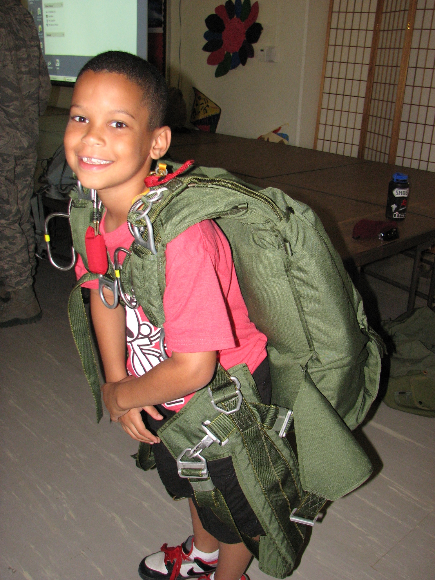 Ivan Pineda tries on a parachute during a presentation on pararescue at Amelia Earhart Intermediate School by the 31st Rescue Squadron. Students from Amelia Earhart Intermediate School experienced various careers during Career Day May 23. Paramedics, airline industry, police and environmental science professionals provided hands on demonstrations about their day-to-day work.(Courtesy Photo)
