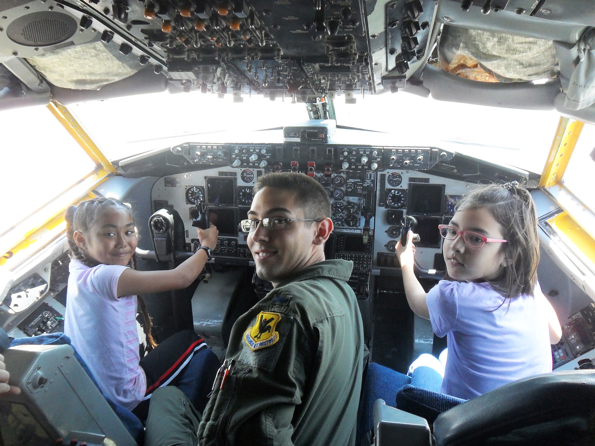 Jaila Haley and Kristina Kennedy learn about the cockpit of a KC-135 Stratotanker from 1st Lt.Alan Herbol, 909th Air Refueling Squadron. Students from Amelia Earhart
Intermediate School experienced various careers during Career Day May 23. Paramedics, airline industry, police and environmental science professionals
provided hands on demonstrations about their day-to-day work.(Courtesy Photo)
