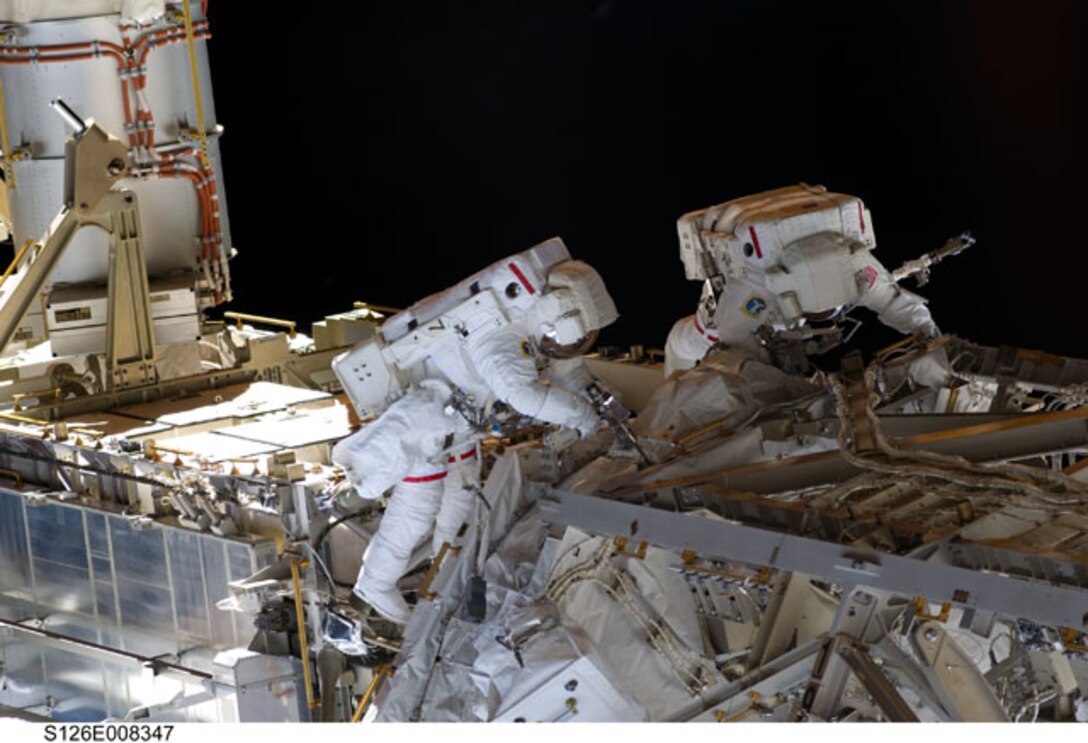 Astronauts Heidemarie Stefanyshyn-Piper (left), and Shane Kimbrough perform construction and maintenance on the International Space Station.