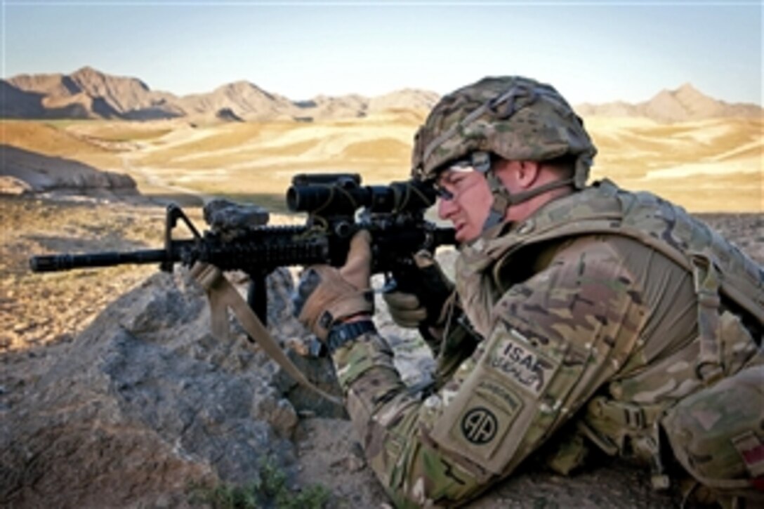 A U.S. paratrooper pulls security during a combat operation in Afghanistan's Ghazni province, June 2, 2012. The soldier is assigned to the 82nd Airborne Division’s 1st Brigade Combat Team. Helicopters delivered fellow paratroopers and Afghan soldiers into the rugged mountain terrain.