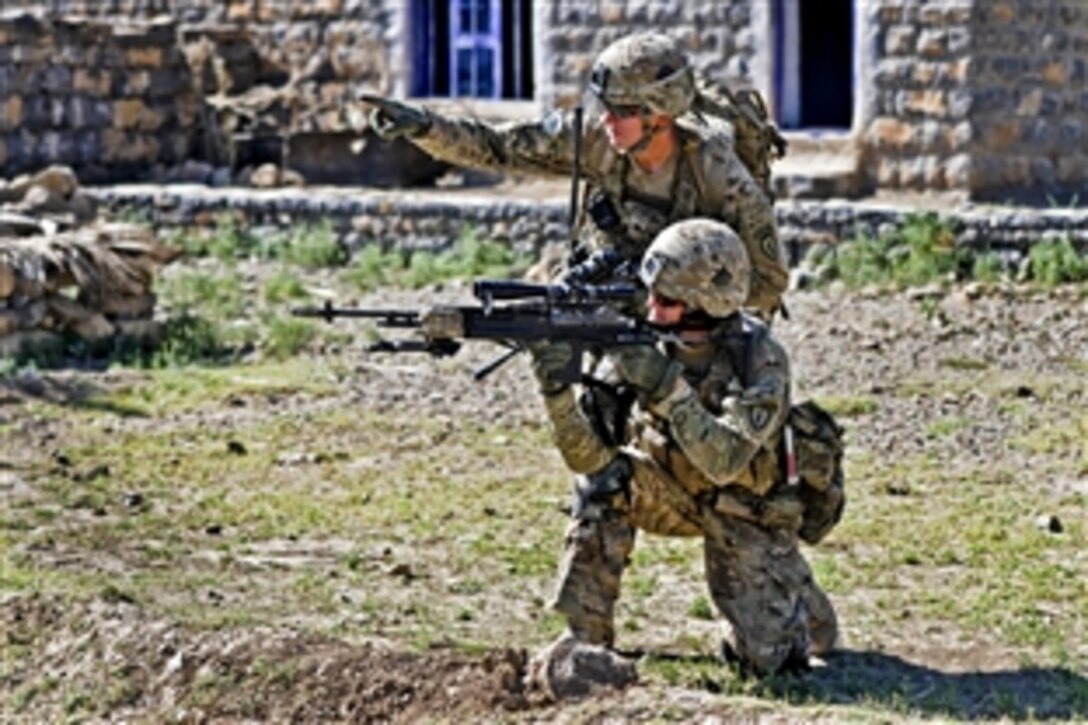 U.S. Army Cpl. Brian Lewis, back, points out a possible enemy location to U.S. Army Pfc. Josh Ball during a dismounted patrol in Shaway Valley in Afghanistan's Khowst province, June 2, 2012. Lewis, a team leader, and Ball, a marksman, are assigned to Company B, 1st Battalion, 501st Infantry Regiment.