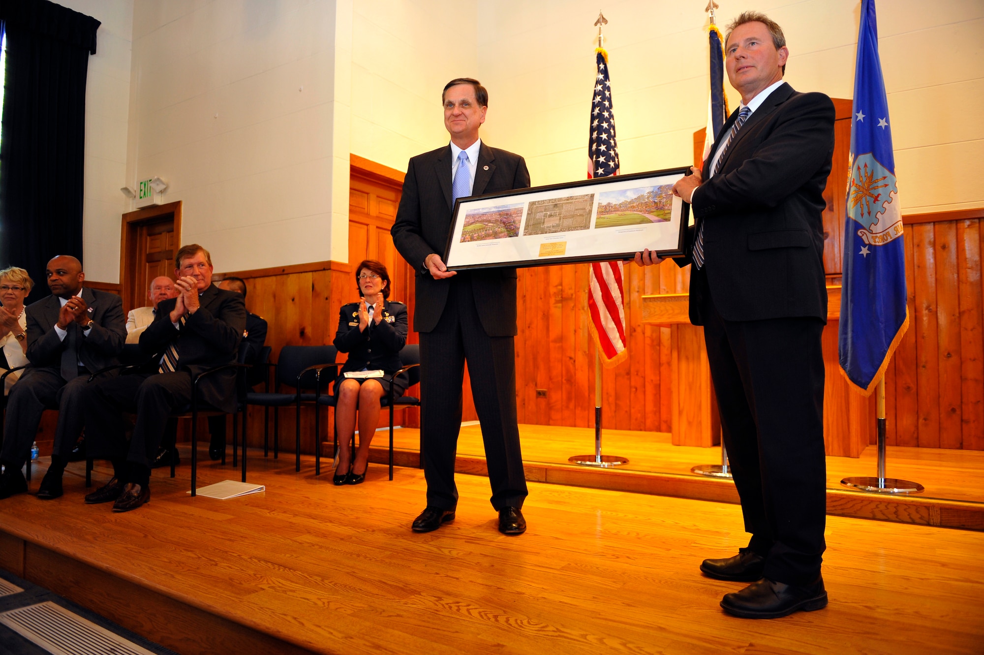 Denver and Air Force Personnel Center leaders watch as a lithograph is presented to Montgomery Force, right, by Stephen TerMaath in Denver on May 31, 2012. The presentation marked the turn-over of the Buckley Annex, the last 70 acres of the former Lowry Air Force Base, to the city of Denver. Force is the Lowry Redevelopment Authority executive director and TerMaath is the Base Realignment and Closure Program Management division chief. (U.S. Air Force photo/Staff Sgt. Kathrine McDowell)