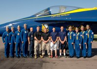 The U.S. Navy Flight Demonstration Squadron, the Blue Angels, pose for a photograph with Sgt. Jared Johnson, Sgt. Derrick Fladseth, Jordan Cady and Andrew Schweisthal after performing at the Minnesota Air Spectacular June 9. Johnson and Fladseth are recruiters out of the Recruiting Substation Mankato office. Cady and Schweisthal are currently enlisted in the Delayed Entry Program. The Marine Corps hosted a fitness challenge at the event.