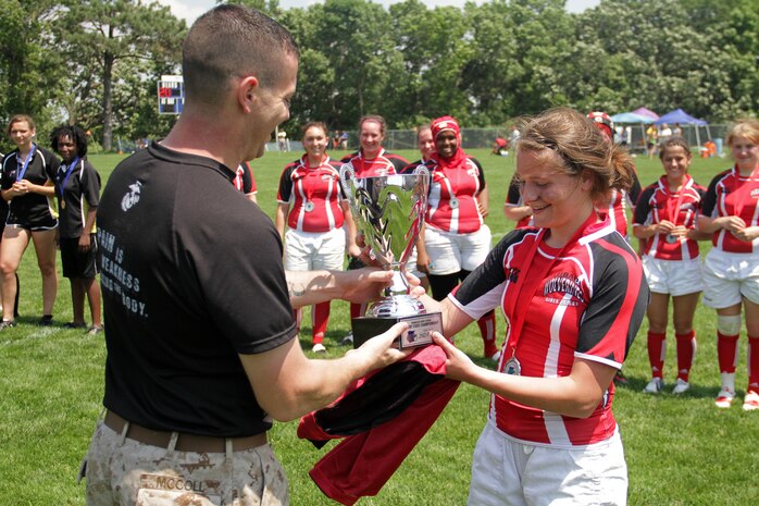 Recruiting Substation Buffalo's Staff Sgt. Steven McColl presents Faribault Rugby Football Club Captain Lorelei Tinaglia with a trophy for placing second in the Minnesota State High School Rugby Girls Tier 2 Tournament June 10. The Wolverines lost to Burnsville 29-15. Last year the Faribault-based team placed third in the playoffs. For additional imagery from the event, visit www.facebook.com/rstwincities.