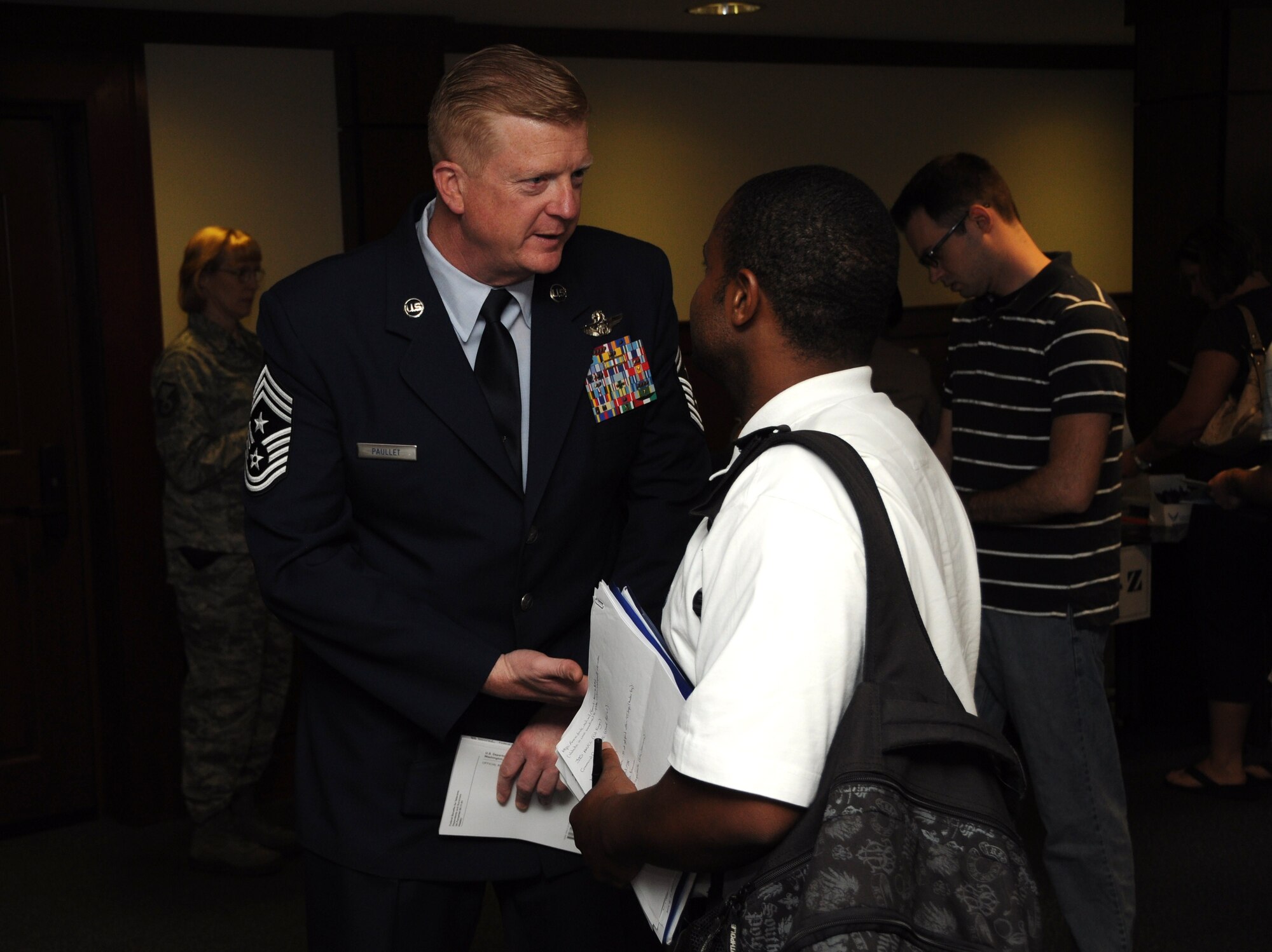 Chief Master Sgt. David R. Paullet, Air Reserve Personnel Center command chief master sergeant, introduces himself to an Air Force Individual Ready Reserve member at the Joint Base Charleston, S.C. IRR muster June 08, 2012. The muster gave IRR members the opportunity to update their contact information and medical records as well as receive information about current veteran’s benefits and U.S. Air Force Reserve opportunities. (U.S. Air Force Photo/Staff Sgt. Shane Ellis)