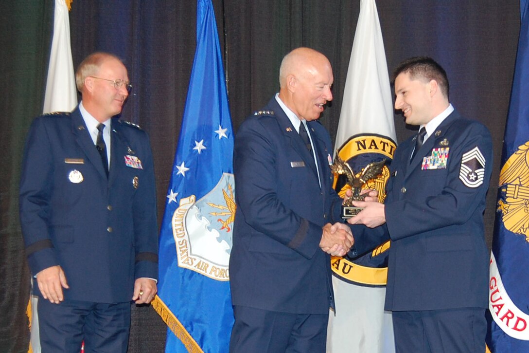 RENO, Nev. - Chief Master Sgt. William Yockell, human resource advisor for the Alaska Air National's 176 Wing, receives Human Resource Advisor of the Year Award from the Air National Guard Director Lt. Gen. Harry M. Wyatt and Gen. Craig R. McKinley, Chief National Guard Bureau at the 2012 Joint Diversity conference in Reno in May. National Guard photo.