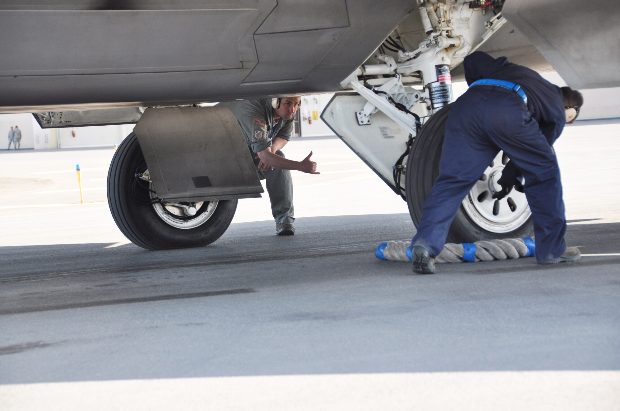 Tech. Sgt.  Dana Rosso, 477th AMXS, signals to Tech. Sgt. Bobby Breher, 477th AMXS, that he has completed his checks during the an end of runway inspection during the 477th Fighter Group Unit Training Assembly weekend here June 9.  During an end of runway inspection the maintainers inspect the landing gear, hydraulic systems, weapons systems and all exterior panels and doors for leaks, loose or missing hardware or other damage that would be unsafe for flight. The UTAs are an opportunity for the pilots and maintainers assigned to the 477th FG to conduct Reserve flying operations.  During the week the Reserve pilots and maintainers integrate with their active duty counterparts in the 525th and 90th Fighter Squadrons. (U.S. Air Force photo/Capt. Ashley Conner) 