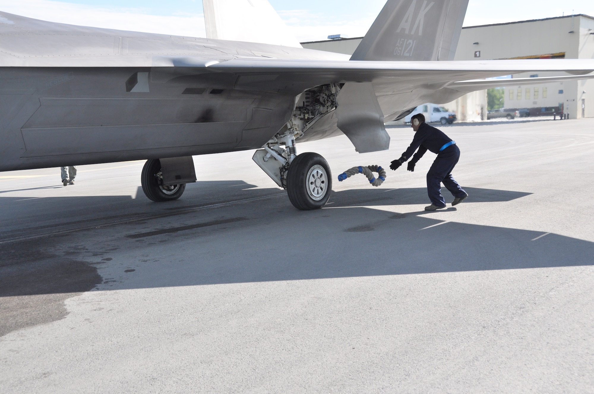 Tech. Sgt. Bobby Breher, 477th AMXS, throws a chock rope before conducting an end of runway inspection during the 477th Fighter Group Unit Training Assembly weekend here June 9.  During an end of runway inspection the maintainers inspect the landing gear, hydraulic systems, weapons systems and all exterior panels and doors for leaks, loose or missing hardware or other damage that would be unsafe for flight. The UTAs are an opportunity for the pilots in the 302nd Fighter Squadron to conduct Reserve flying operations.  During the week the Reserve pilots and maintainers integrate with their active duty counterparts in the 525th and 90th Fighter Squadrons. (U.S. Air Force photo/Capt. Ashley Conner) 