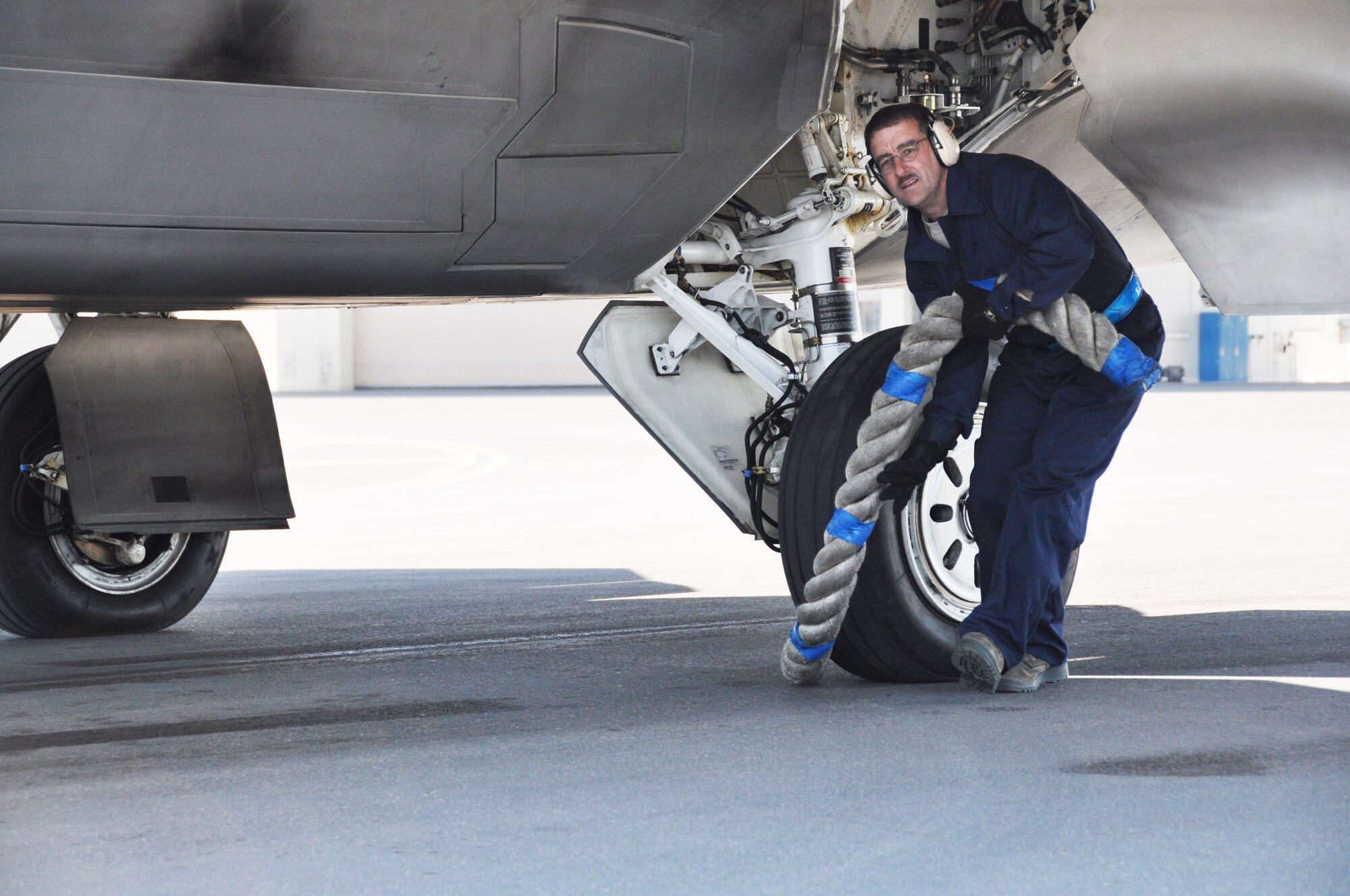 Tech. Sgt. Bobby Breher, 477th AMXS, removes the chock rope from an F-22 Raptor after completing an end of runway inspection during the 477th Fighter Group Unit Training Assembly weekend here June 9.  During an end of runway inspection the maintainers inspect the landing gear, hydraulic systems, weapons systems and all exterior panels and doors for leaks, loose or missing hardware or other damage that would be unsafe for flight. The UTAs are an opportunity for the pilots in the 302nd Fighter Squadron to conduct Reserve flying operations.  During the week the Reserve pilots and maintainers integrate with their active duty counterparts in the 525th and 90th Fighter Squadrons. (U.S. Air Force photo/Capt. Ashley Conner) 