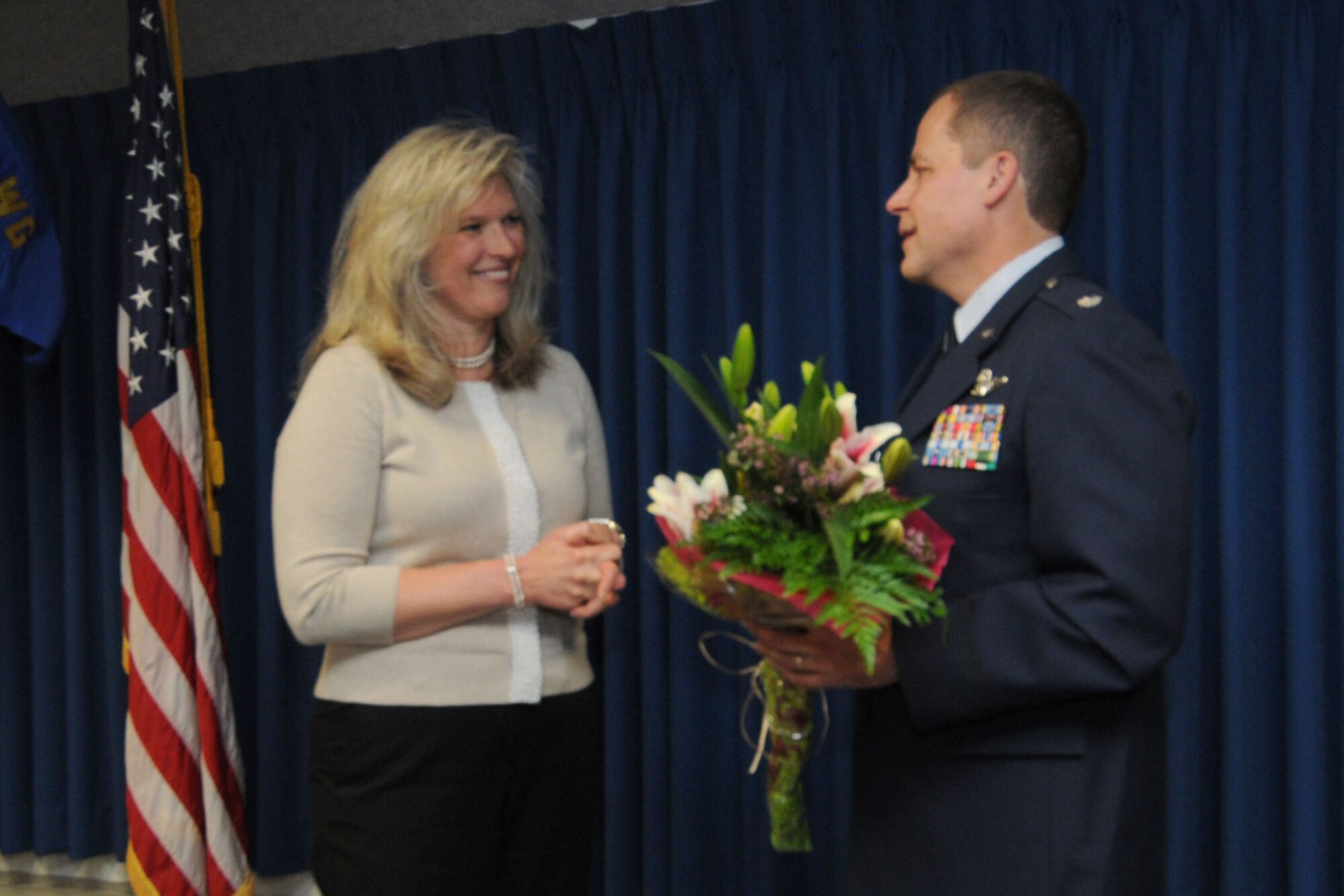JOINT BASE ELMENDORF-RICHARDSON, Alaska - Lt. Col. Scott Coniglio shows his appreciation to his wife, Kerstin, for her support during his military career with an arrangement of flowers June 9, 2012. Lt. Col. Coniglio is the new commander of the 176 Maintenance Squadron. He will be in charge of more than 200 Airmen responsible for the maintenance of 176 Wing's fixed-wing aircraft and helicopters. National Guard Photo by Tech. Sgt. Jennifer Theulen.