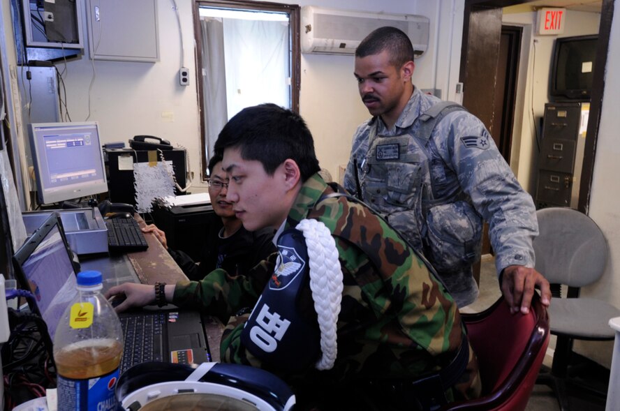 Airman 1st Class Leonardo Akens, right, 8th Security Forces Squadron member, works with Korean security forces members from the 38th Fighter Group May 1, 2012, at Kunsan Air Base, Republic of Korea. The units hold combined exercises to ensure they work as efficiently together as possible. (U.S. Air Force illustration/Senior Airman Jessica Hines)
