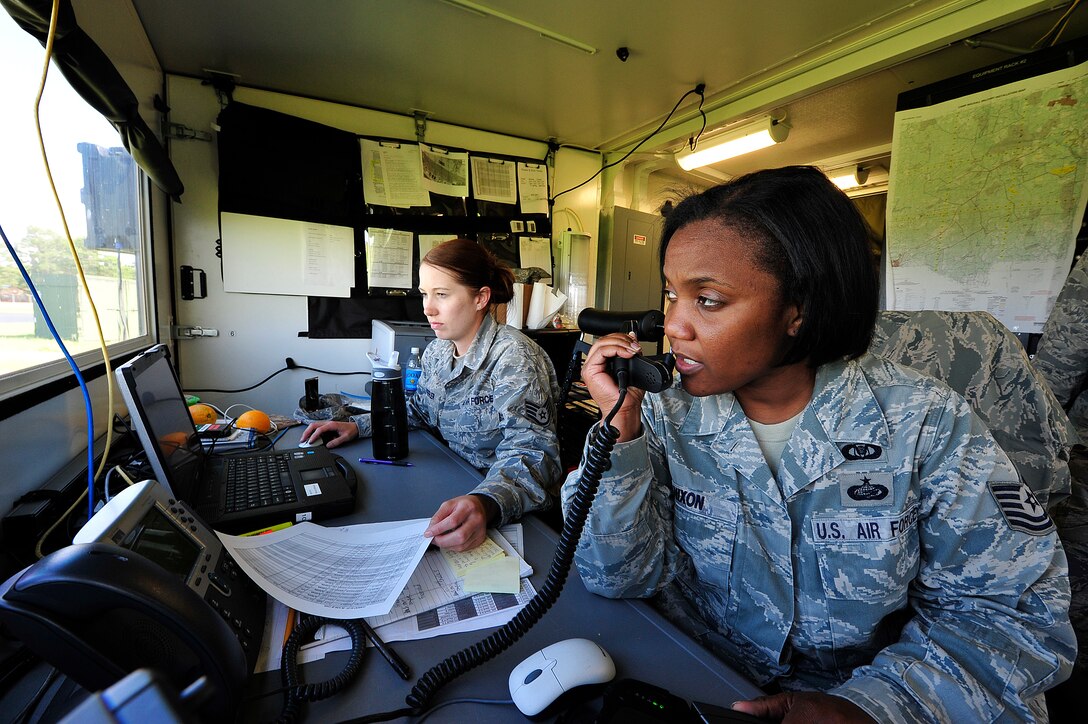From left, Staff Sgt. Nicole Shreffler and Tech. Sgt. Haniyyah Nixon, command post controllers from the 621st Contingency Response Wing, at Joint Base McGuire-Dix-Lakehurst, N.J. provide air mobility logistics support at Mackall Army Airfield, N.C. during Joint Operational Access Exercise 12-02, June 6.  The JOAX is a two-week forcible entry and ground combat exercise to prepare Air Force and Army service members to respond to worldwide crises and contingencies. (U.S. Air Force photo by Tech. Sgt. Parker Gyokeres)