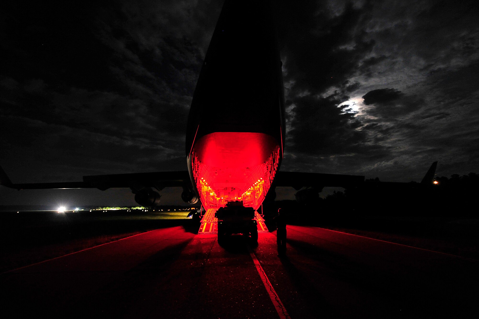 A C-17 Globemaster III offloads passengers and cargo under blackout conditions at an intermediate staging base established at Mackall Army Airfield, N.C. during Joint Operational Access Exercise 12-02, June 4, 2012.  JOAX is a two-week exercise to prepare Air Force and Army service members to respond to worldwide crises and contingencies. (U.S. Air Force photo by Tech. Sgt. Parker Gyokeres)