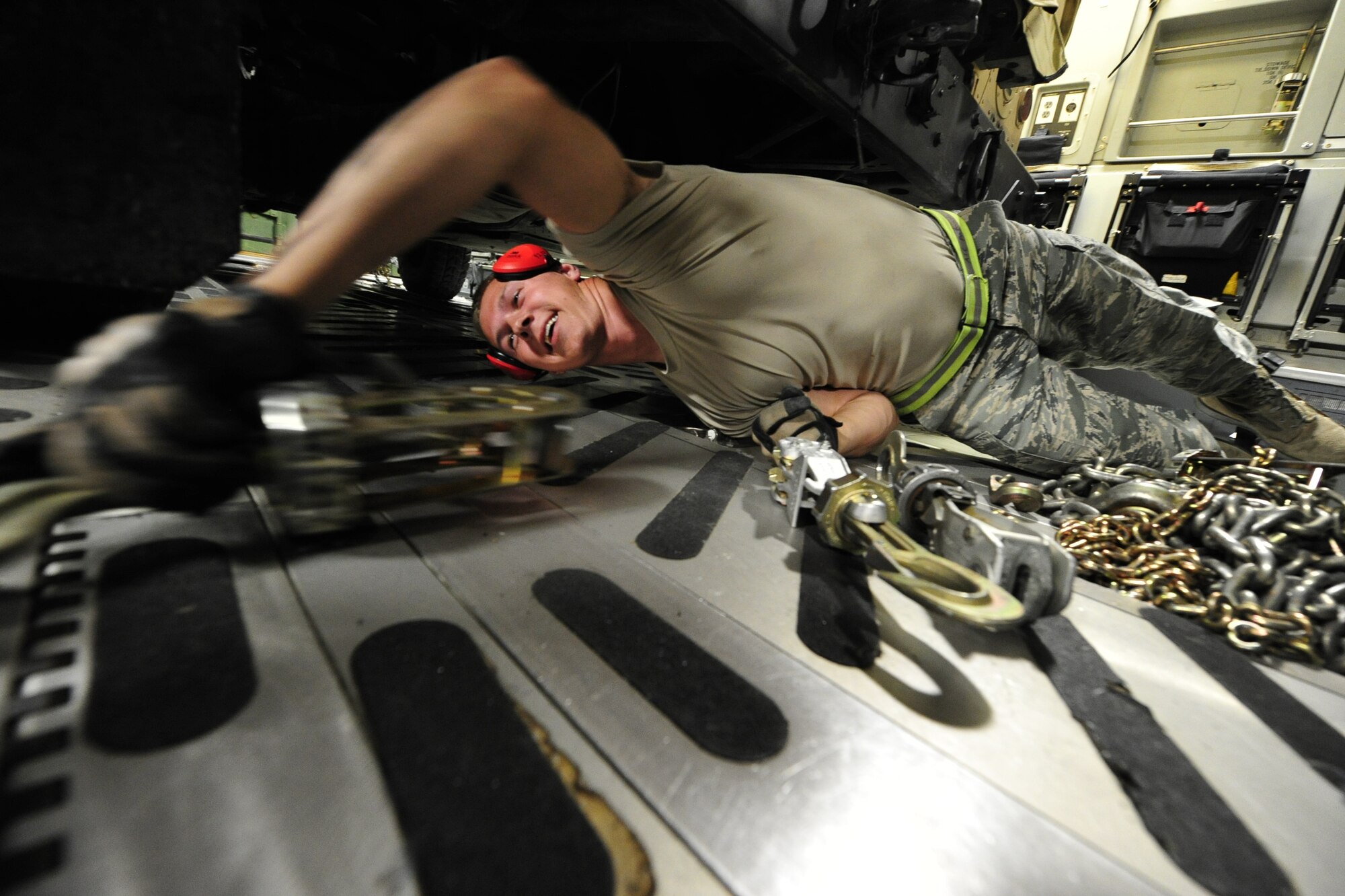 Airman 1st Class Kolt Putnam, aerial transportation apprentice with the 621st Contingency Response Wing from Joint Base McGuire-Dix-Lakehurst, N.J. removes chains securing a vehicle belonging to the 10th Mountain Division, based at Fort Drum, N.Y., aboard a C-17 Globemaster III at Mackall Army Airfield, N.C. during Joint Operational Access Exercise 12-02, June 3.  JOAX is a two-week forcible entry and ground combat exercise to prepare Air Force and Army service members to respond to worldwide crises and contingencies. (U.S. Air Force photo by Tech. Sgt. Parker Gyokeres)