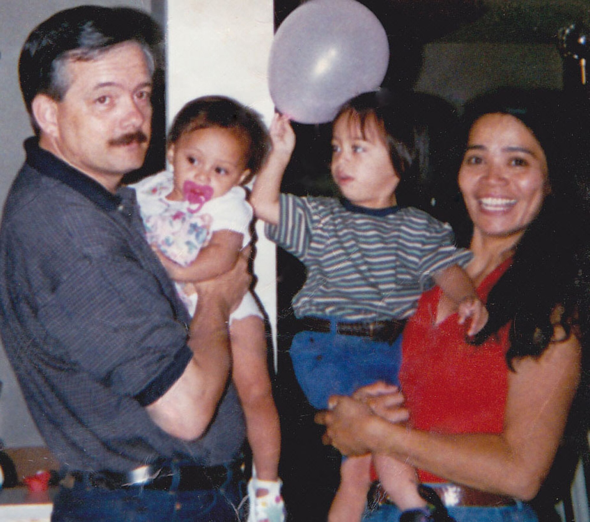 Proud grandparents Dave and Loida hold Jerry and Myya when they were just toddlers. (Courtesy Photo)
