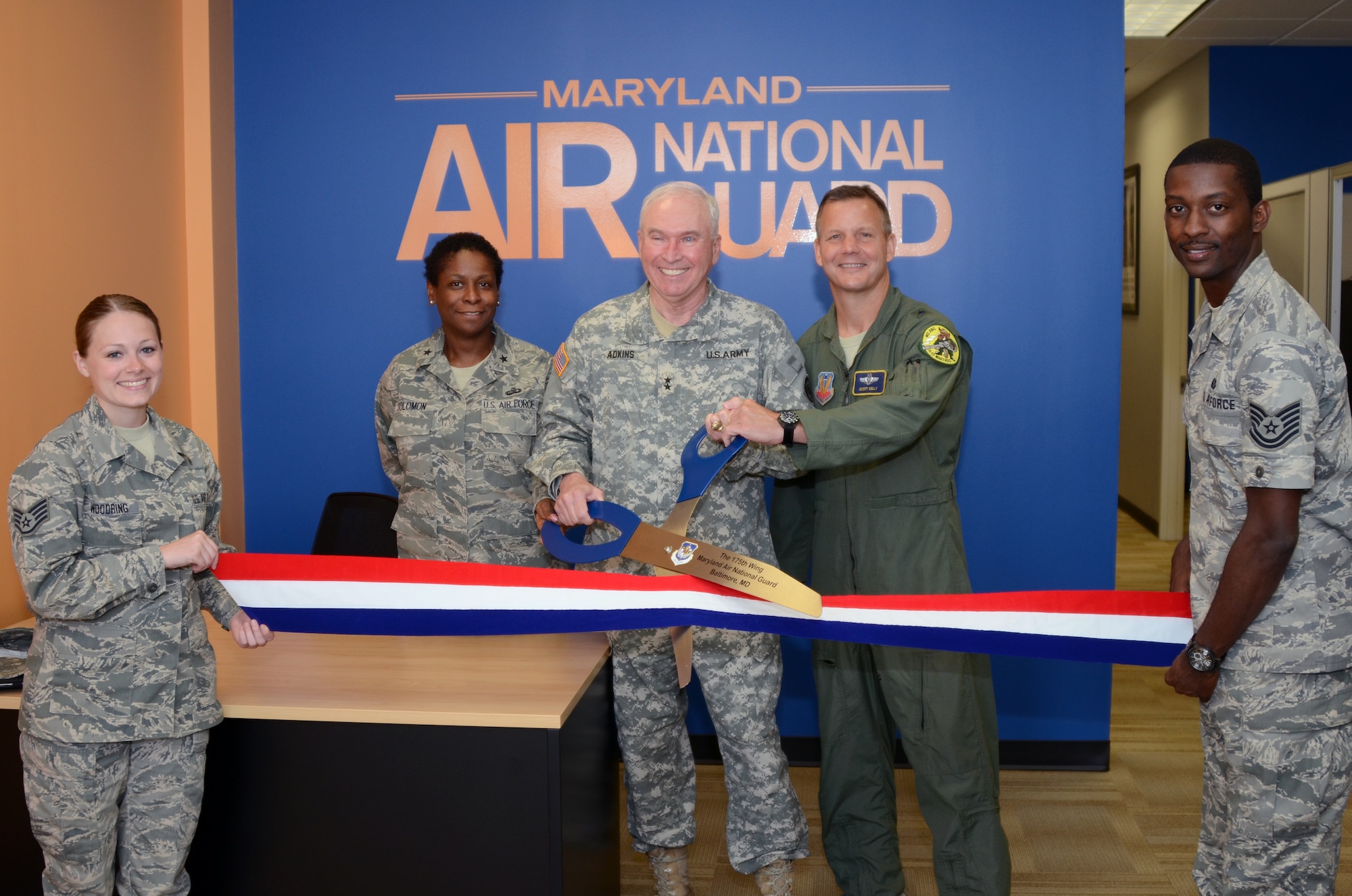U.S. Army Maj. Gen. James A. Adkins, Adjutant General, Maryland National Guard, along with U.S. Air Force Brig. Gen. Allyson R. Solomon, Assistant Adjutant General-Air, and Brig. Gen. Scott Kelly, 175th Wing Commander, cut the ribbon of the new Air National Guard recruiting storefront in Baltimore, Md., on June 9, 2012, while recruiters Staff Sgt. Alexanderia Woodring and Tech Sgt. Robert Carr hold on. (National Guard photo by Staff Sgt. Benjamin Hughes)