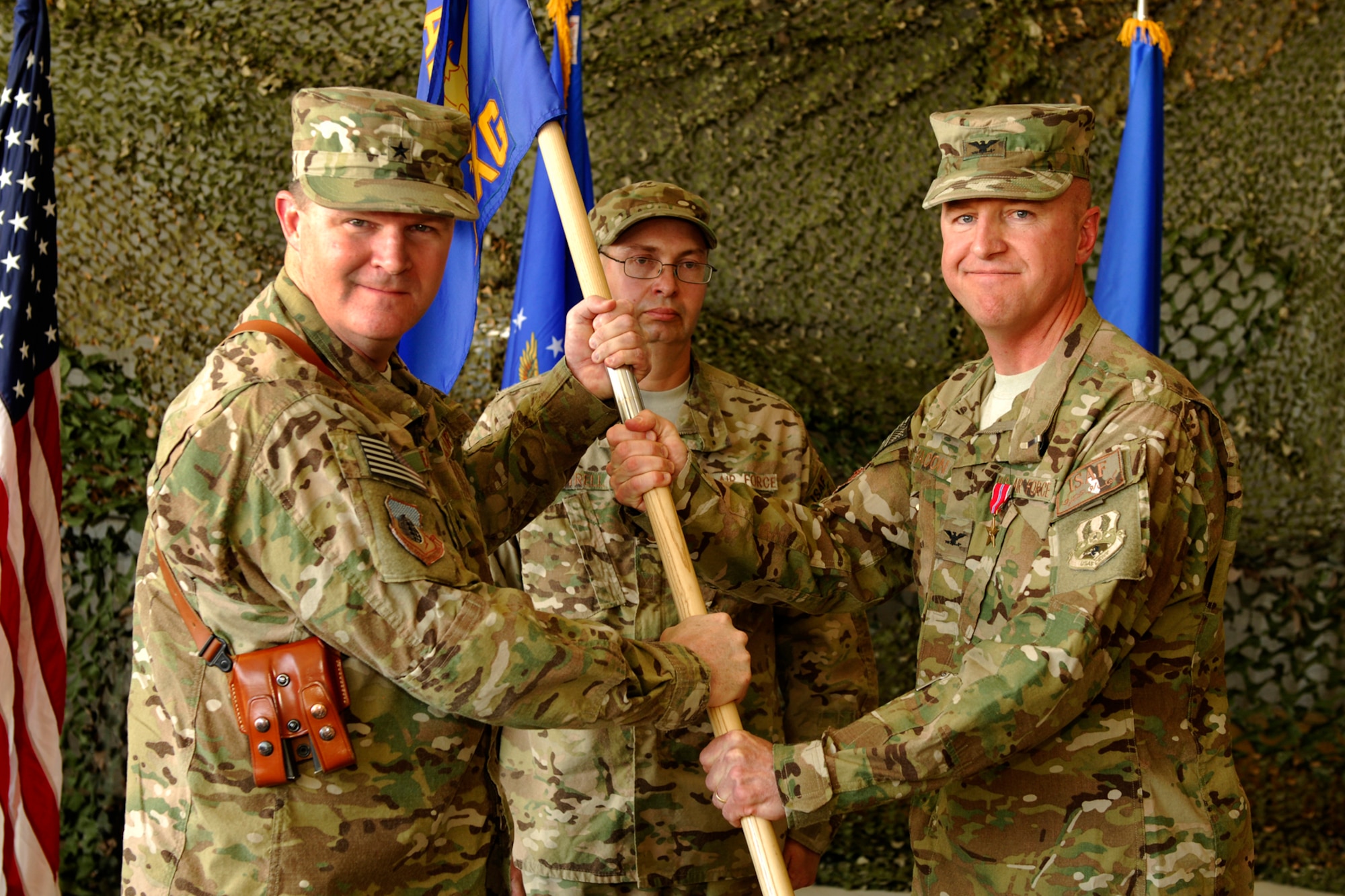 Brig. Gen. Thomas Deale, 455th Air Expeditionary Wing commander, receives the 455th Expeditionary Maintenance Group guidon from Col. Geoffrey Bacon as Bacon relinquishes command of the 455 EMXG at Bagram Airfield, Afghanistan, June 10, 2012. Bacon commanded the 455 EMXG group from June 10, 2011 to June 10, 2012 and is a career aircraft and munitions maintenance officer with extensive experience on various U.S. Air Force aircraft, to include the F-16 Eagle, A-10 Thunderbolt II, B-52 Stratofortress, KC-135 Stratotanker and the KC-10 Extender. (U.S Air Force photo/Staff Sgt. Jeff Nevison)