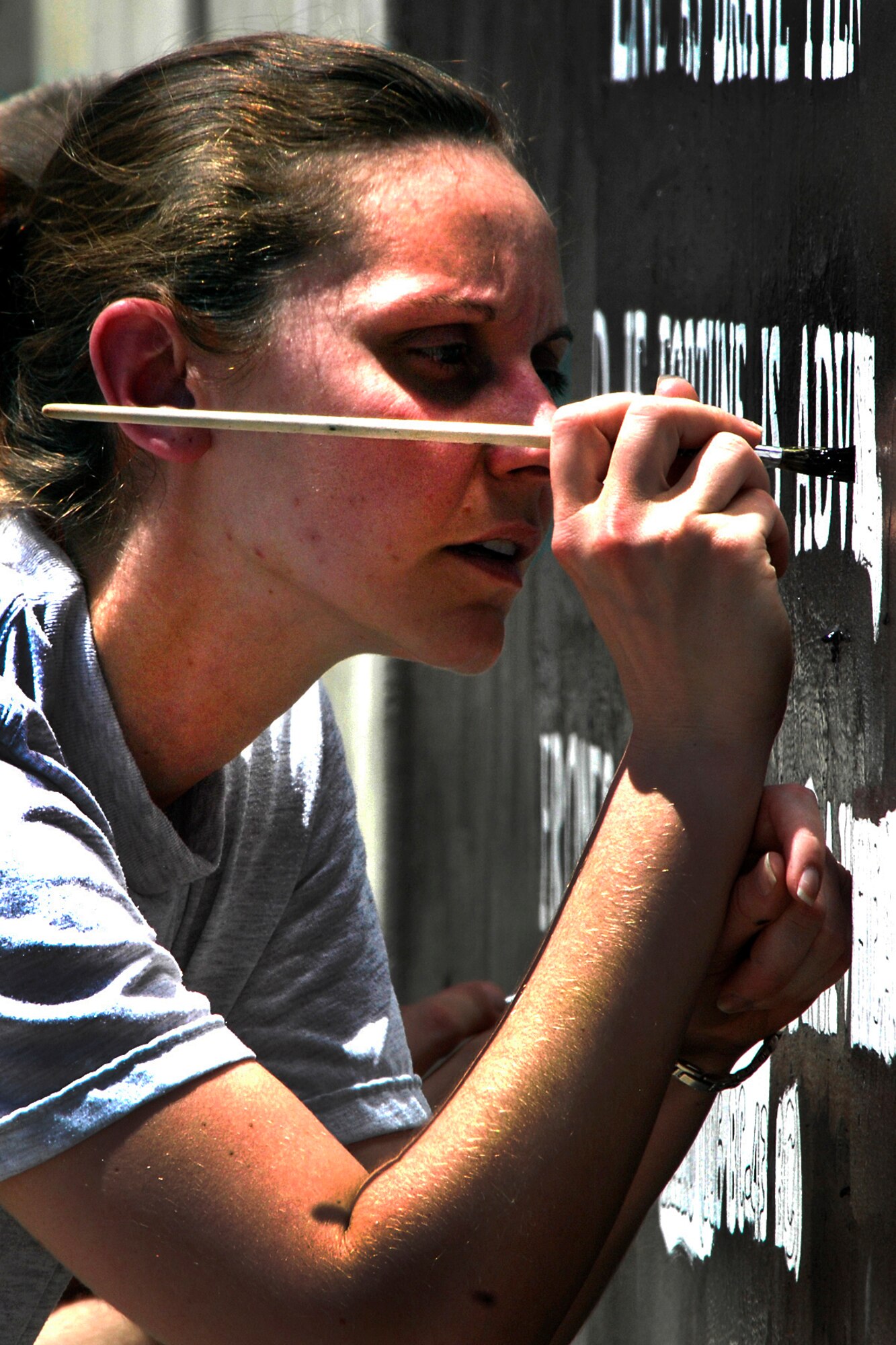 Staff Sgt. Megan Seppala, Route 5/6 Noncommissioned Officer Council vice president, paints the Route 5/6 NCO Council wall mural project at Camp Cunningham on Bagram Airfield, Afghanistan, June 9, 2012. Seppala and other Route 5/6 NCO Council volunteers painted the mural to highlight airpower in Afghanistan. All three tiers of the U.S. Air Force Enlisted Corps will paint wall murals, each with a separate Air Force mission theme. (U.S. Air Force photo/Staff Sgt. Jeff Nevison)