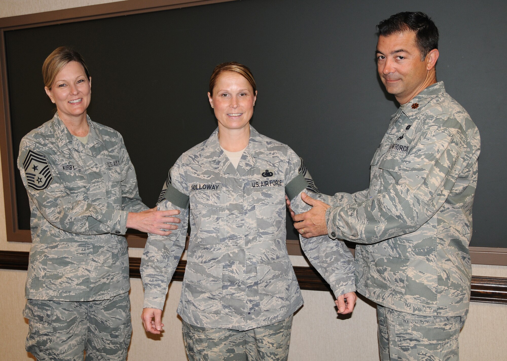 Virginia Air National Guardsman Senior Master Sgt. Kimberly R. Holloway,
192nd Fighter Wing Human Resources Advisor, gets pinned to the rank of chief
by Chief Master Sergeant Brenda K. Kirby, 192nd Fighter Wing Command Chief
Master Sergeant (left) and Major David R. Lands, 192nd Fighter Wing Executive Officer, during her promotion ceremony on May 6, 2012, Langley Air Force Base.
(National Guard photo by Master Sgt. Carlos J. Claudio/Released) 
