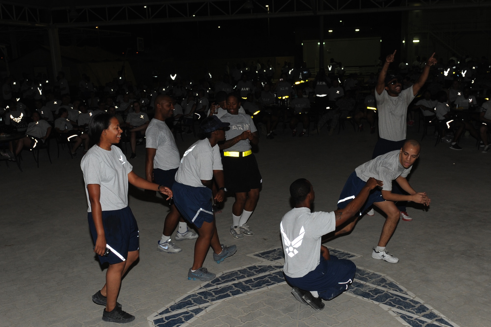 SOUTHWEST ASIA - Airmen and Soldiers dance during a performance by DJ VH1, Lady Gaga's disc jockey,  at the 380th Air Expeditionary Wing Pavilion June 9, 2012. The 380th Expeditionary Force Support Squadron set up the show to boost the morale of the troops.(U.S. Air Force photo/Master Sgt. Scott MacKay)