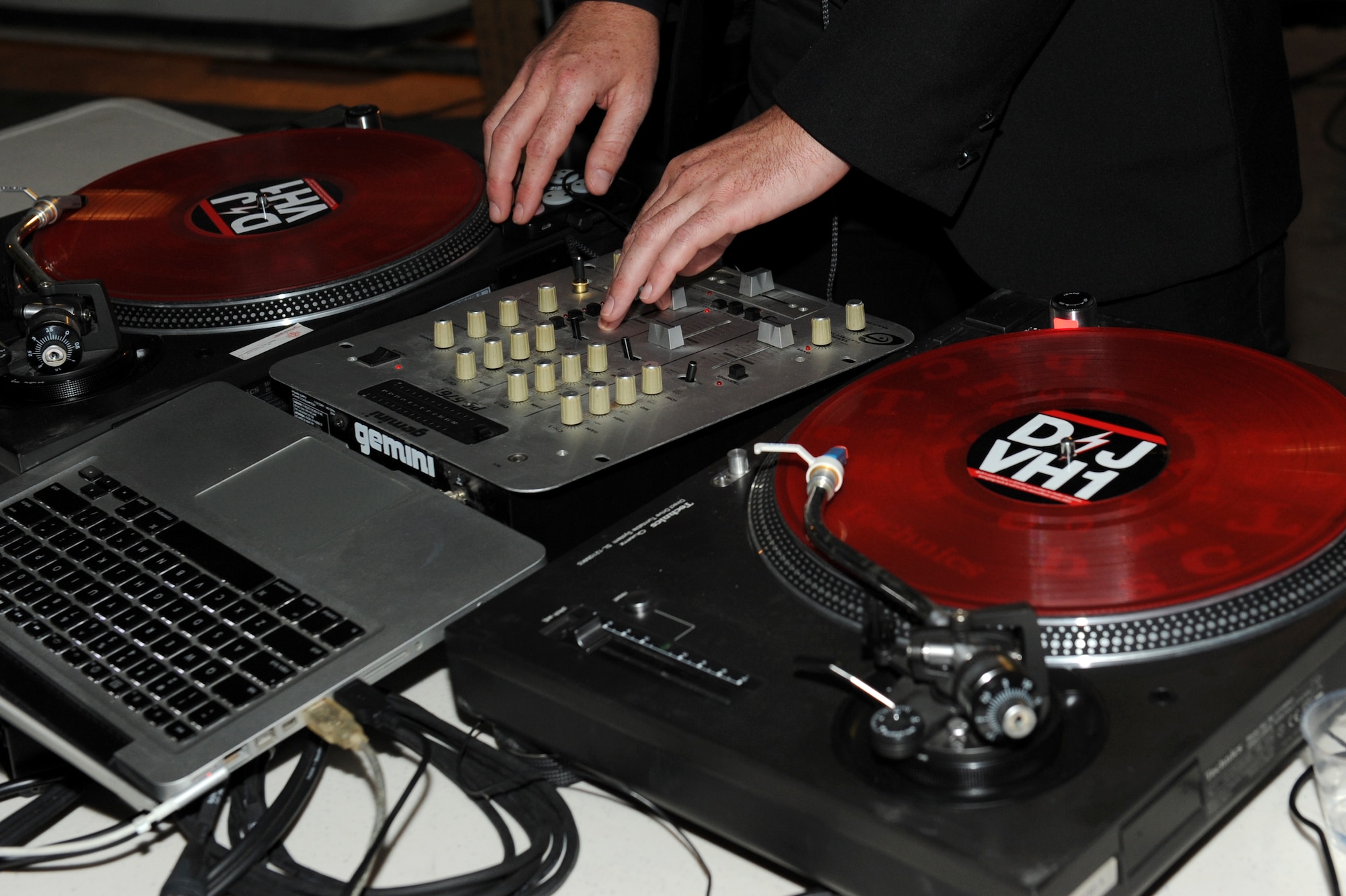 SOUTHWEST ASIA - DJ VH 1, Lady Gaga's disc jockey,  works his turntables during a show for Airmen and Soldiers at the 380th Air Expeditionary Wing Pavilion June 9, 2012. The 380th Expeditionary Force Support Squadron set up the show to boost the morale of the troops. (U.S. Air Force photo/Master Sgt. Scott MacKay)