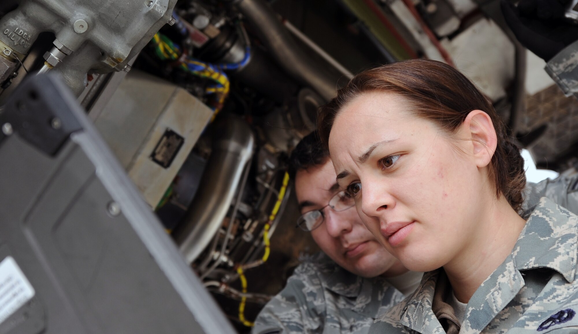 120608-F-MC921-001: Senior Airman Genevieve Ramsey, an aerospace propulsion journeyman, and Staff Sgt. Joseph Leugers, a hydraulic systems craftsman, both from the 15th Aircraft Maintenance Squadron at Joint Base Pearl Harbor-Hickam, Hawaii, reference electronic maintenance manuals while performing maintenance on an engine of a C-17 Globemaster III aircraft from the 535th Airlift Squadron deployed to Joint Base Elmendorf-Richardson, Alaska, as part of RED FLAG-Alaska June 8. RED FLAG-Alaska is one of the largest international air-combat employment exercises in the world and is designed to test the specific capabilities of the military units that take part in the exercise and increase their chance of survival during actual combat. (U.S. Air Force photo by Capt. Ben Sakrisson)